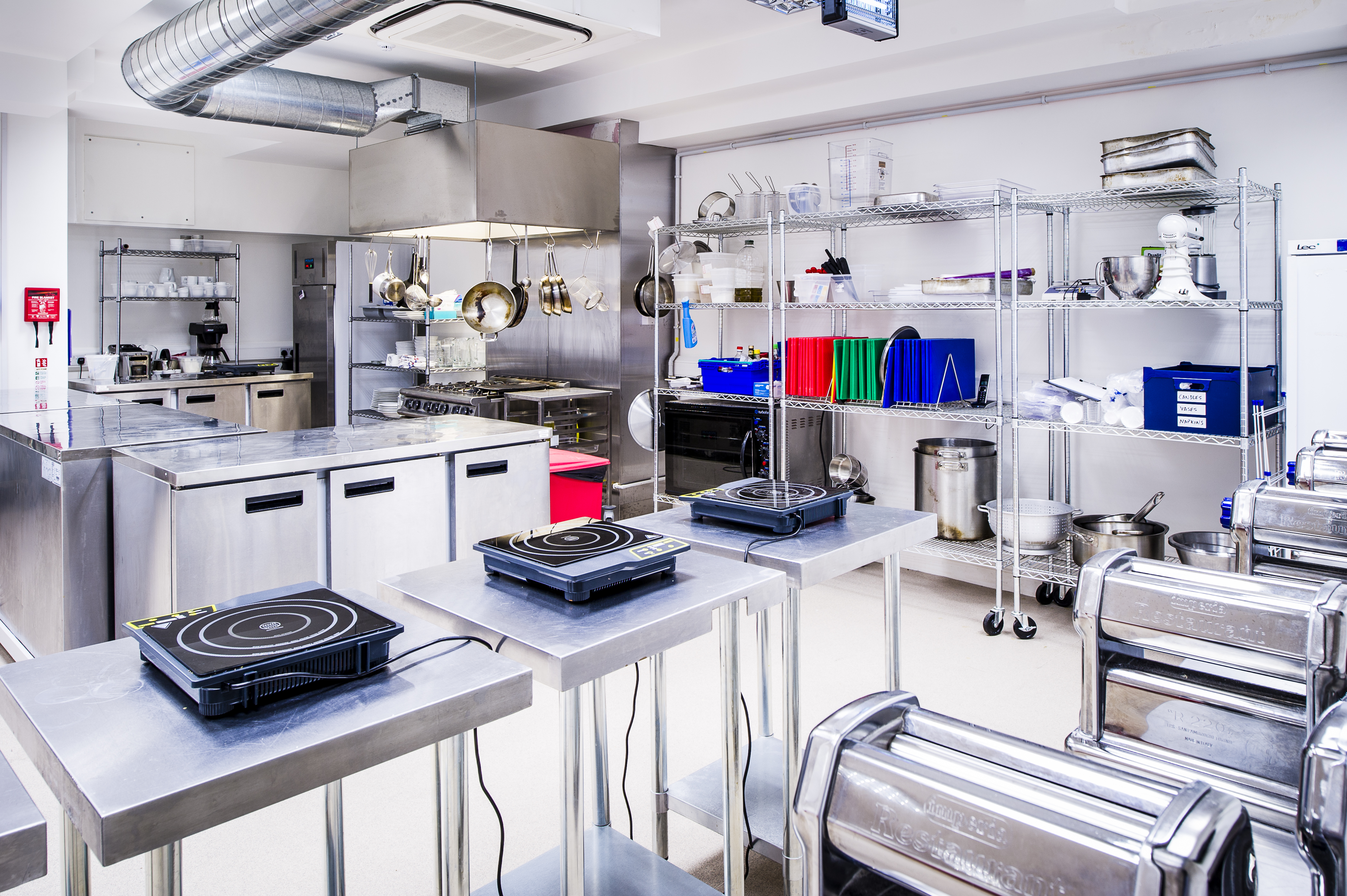 Modern kitchen venue with stainless steel surfaces for culinary events and workshops.