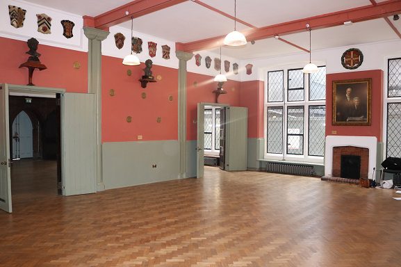 Ashbee Hall meeting room with polished wood floor, ideal for events and gatherings.