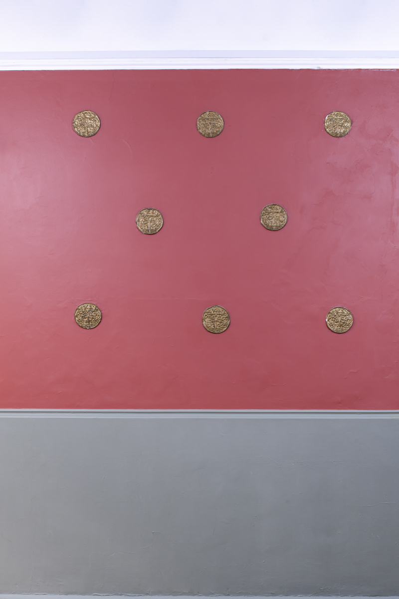 Ashbee Hall's pink wall with gold medallions, perfect for events and photo ops.