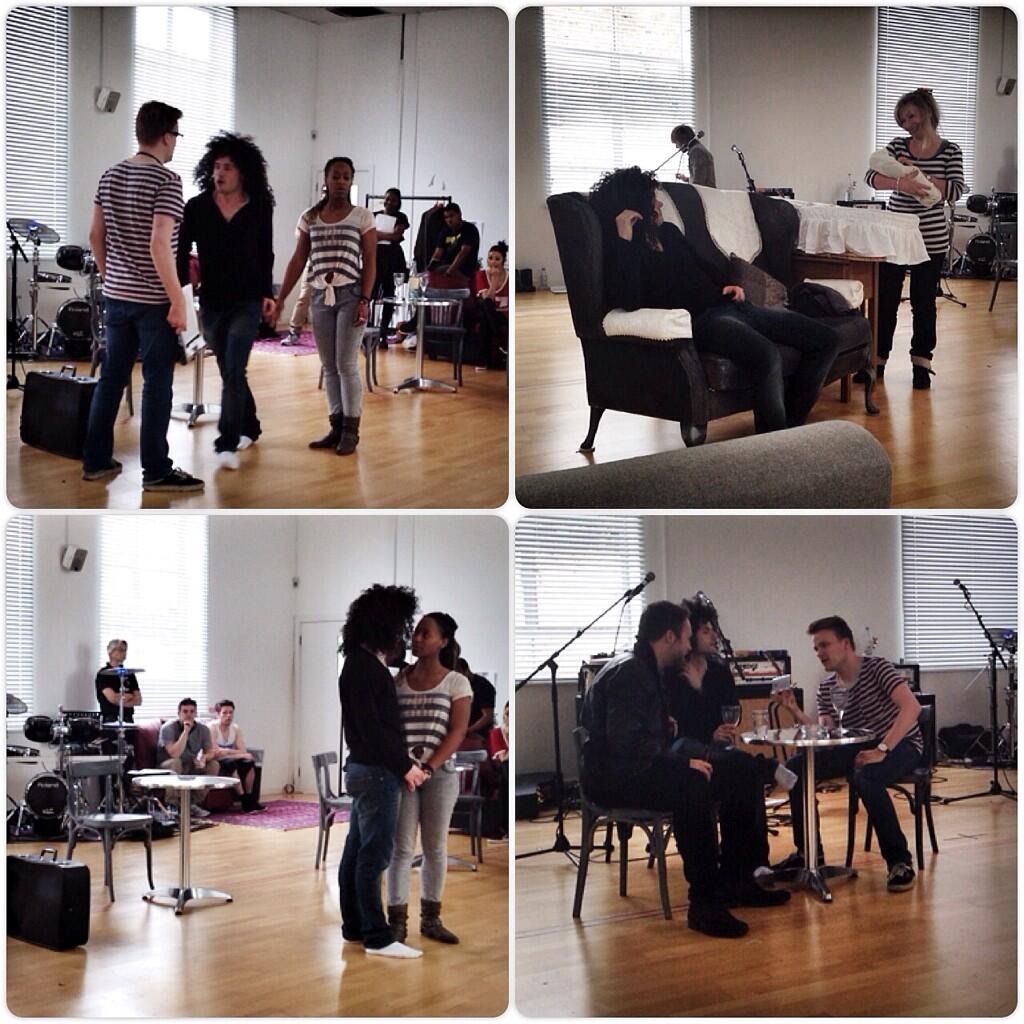 Dynamic rehearsal space at Price Studios with performers, musicians, and flexible seating.