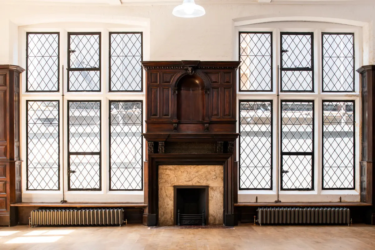 Lecture Hall at Toynbee Hall with diamond-patterned windows, ideal for workshops and networking.