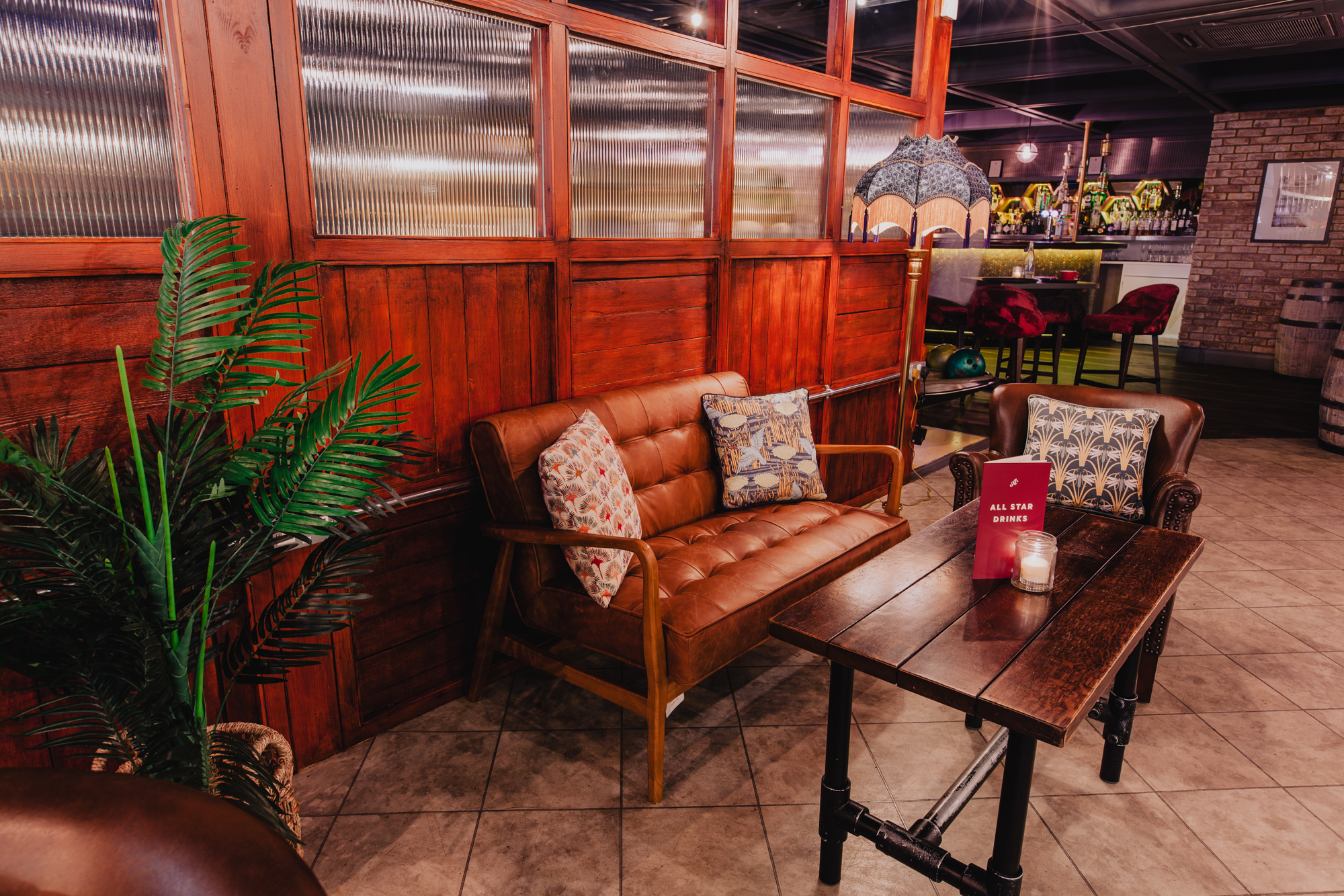 Cozy lounge area at All Star Lanes, perfect for networking events and informal meetings.