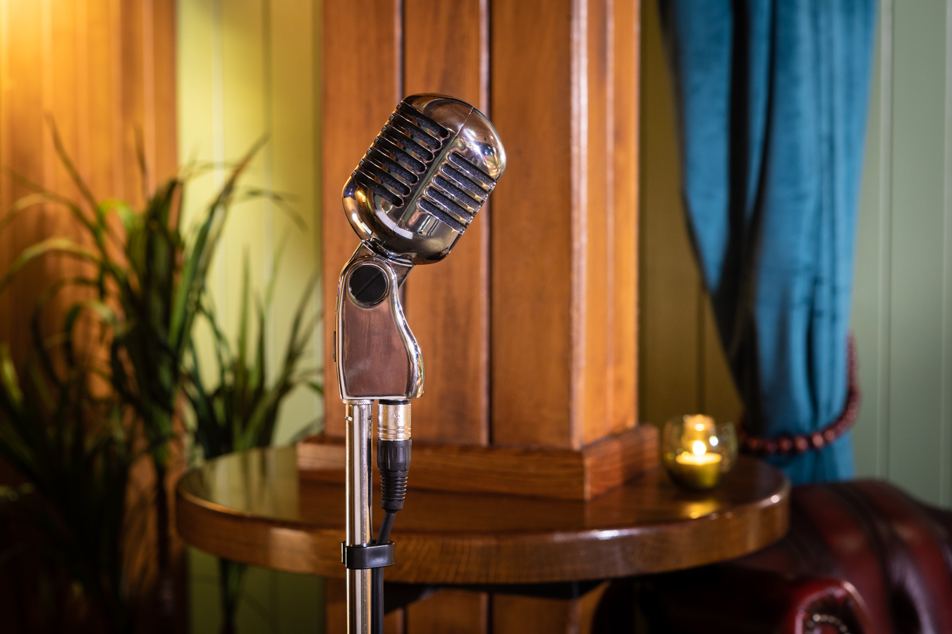 Vintage microphone in cozy Lodge at All Star Lanes, perfect for open mic nights.