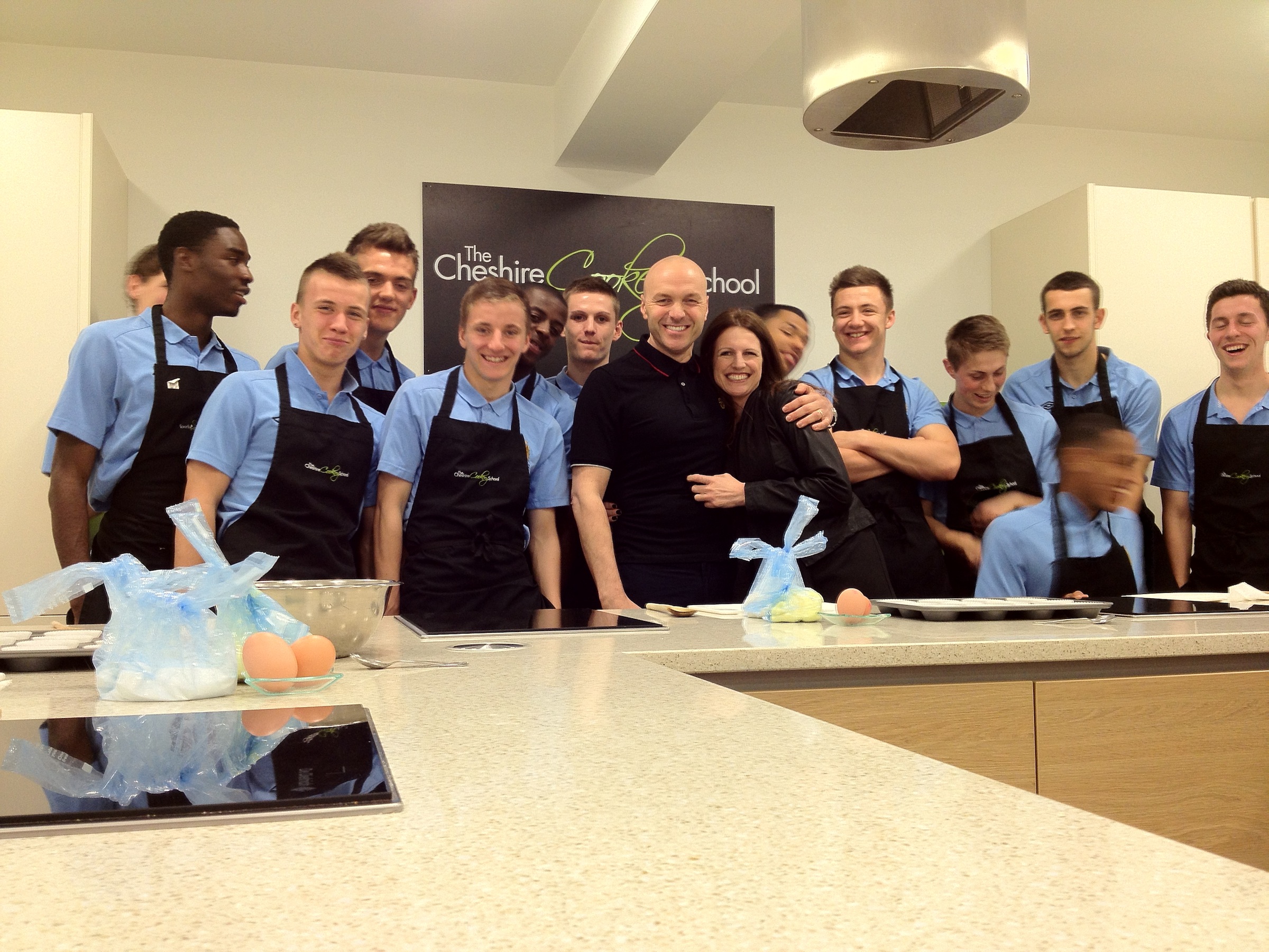 Young chefs in a team-building cooking class at The Cheshire Cookery School.
