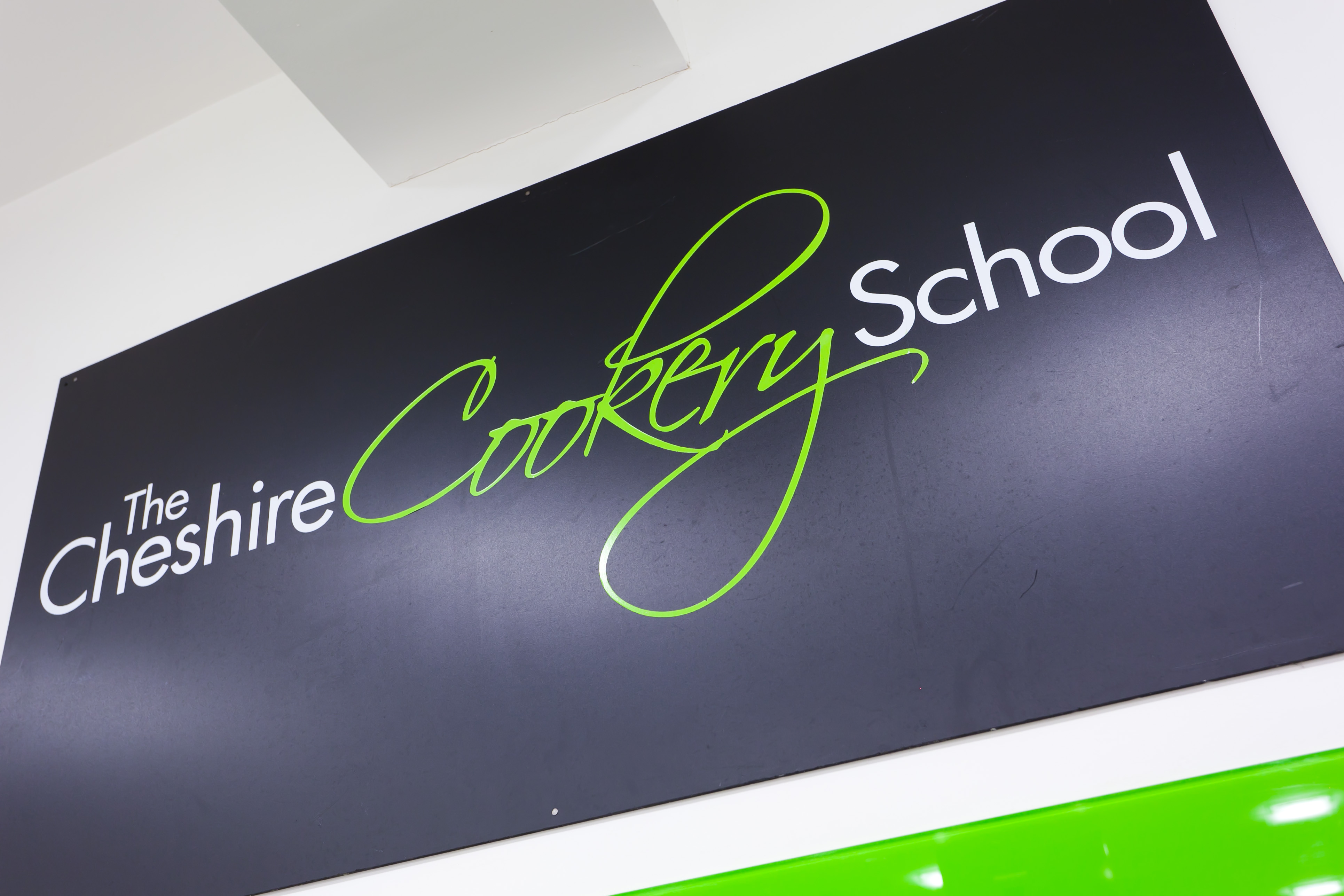 Modern sign of The Cheshire Cookery School, ideal for culinary events and workshops.