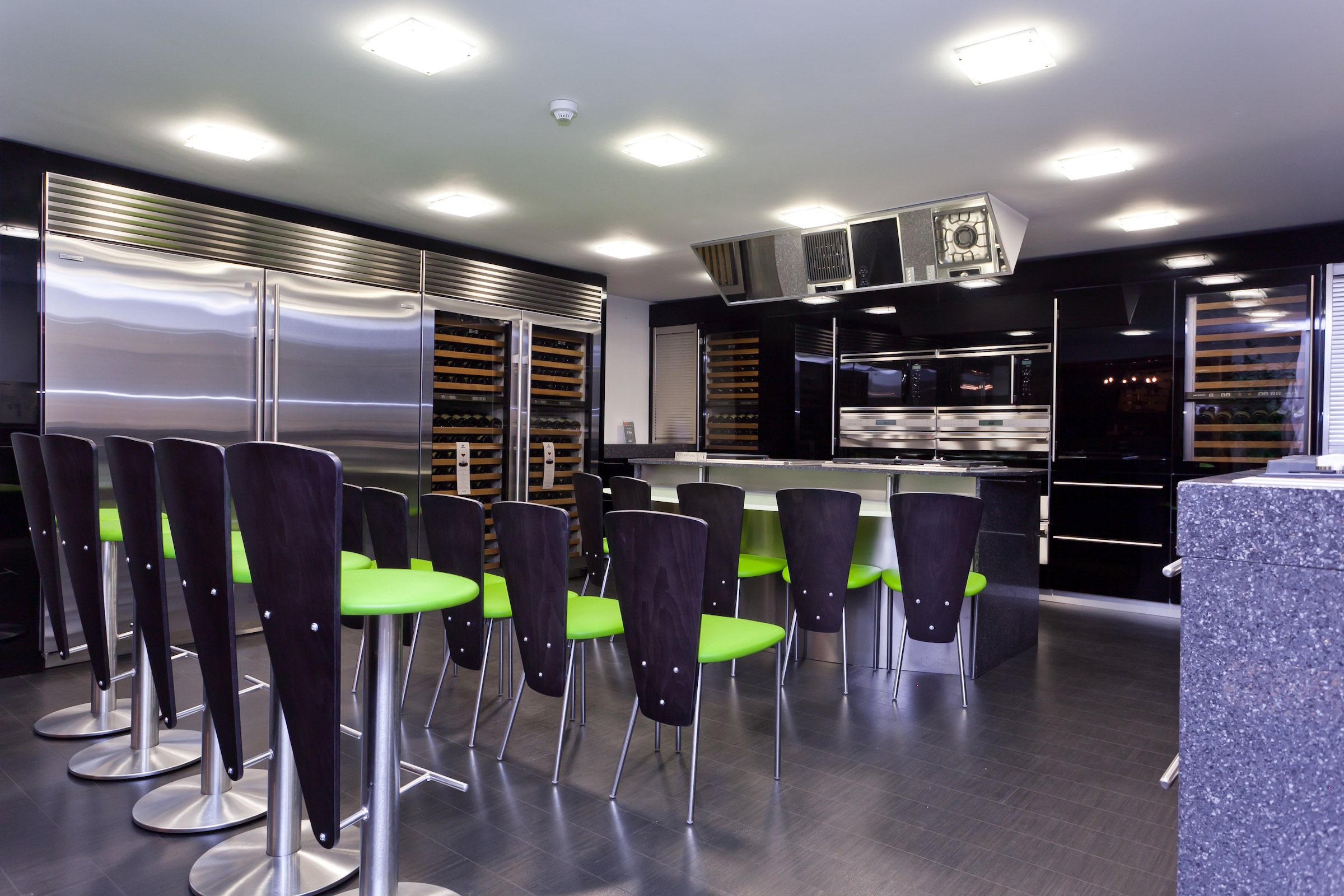 Modern kitchen with stainless steel appliances for culinary events and cooking demonstrations.