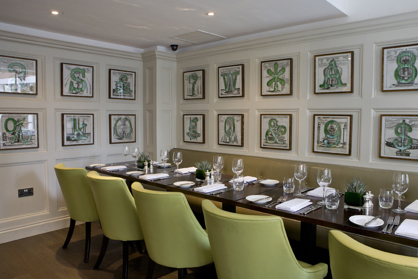 Elegant private dining room with green chairs for meetings and events in Chiswell Street.