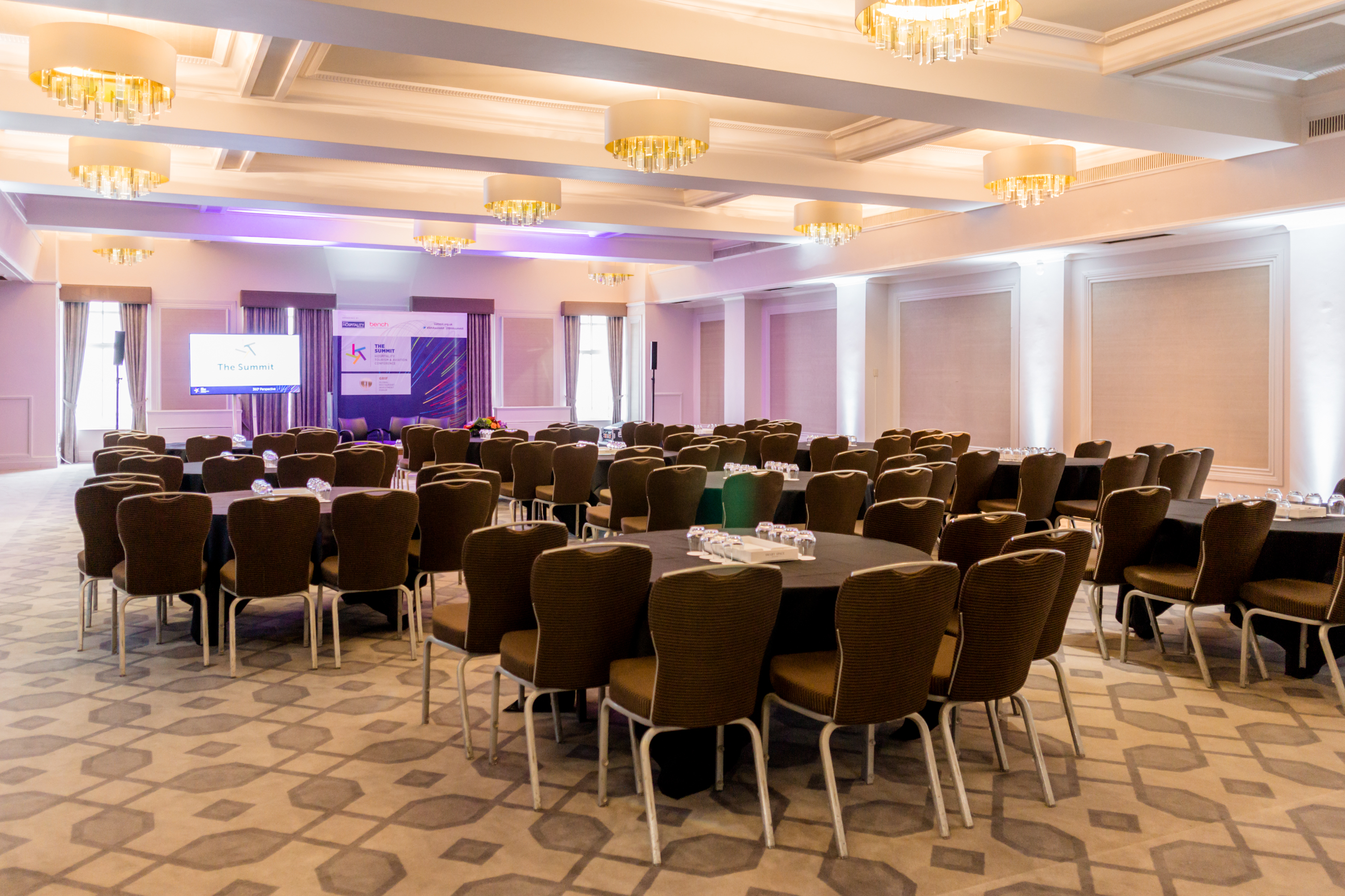 Crown & Cornwall Suite: elegant meeting space with round tables for corporate events.