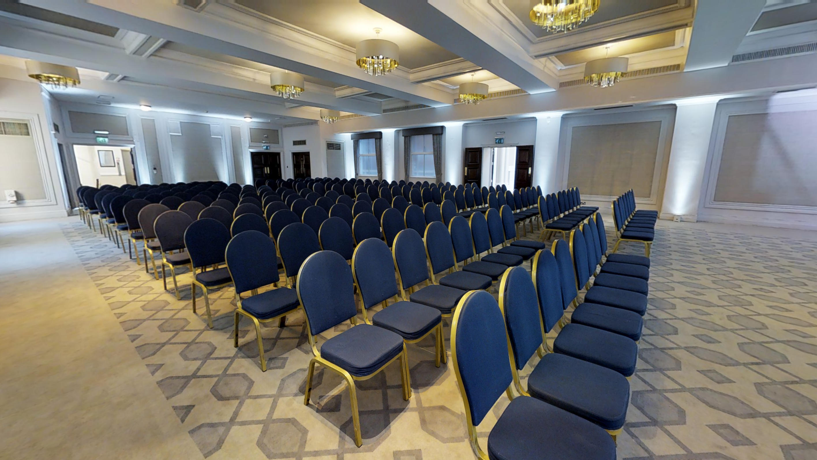 Crown & Cornwall Suite conference room with blue chairs, ideal for presentations and seminars.