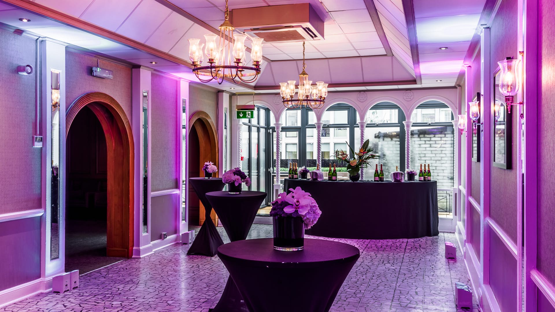 Penthouse event space with chandeliers, ideal for receptions and networking.