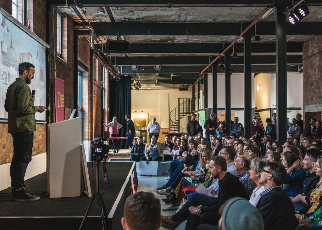 Engaging speaker at modern Paintworks Event Space during a successful event.