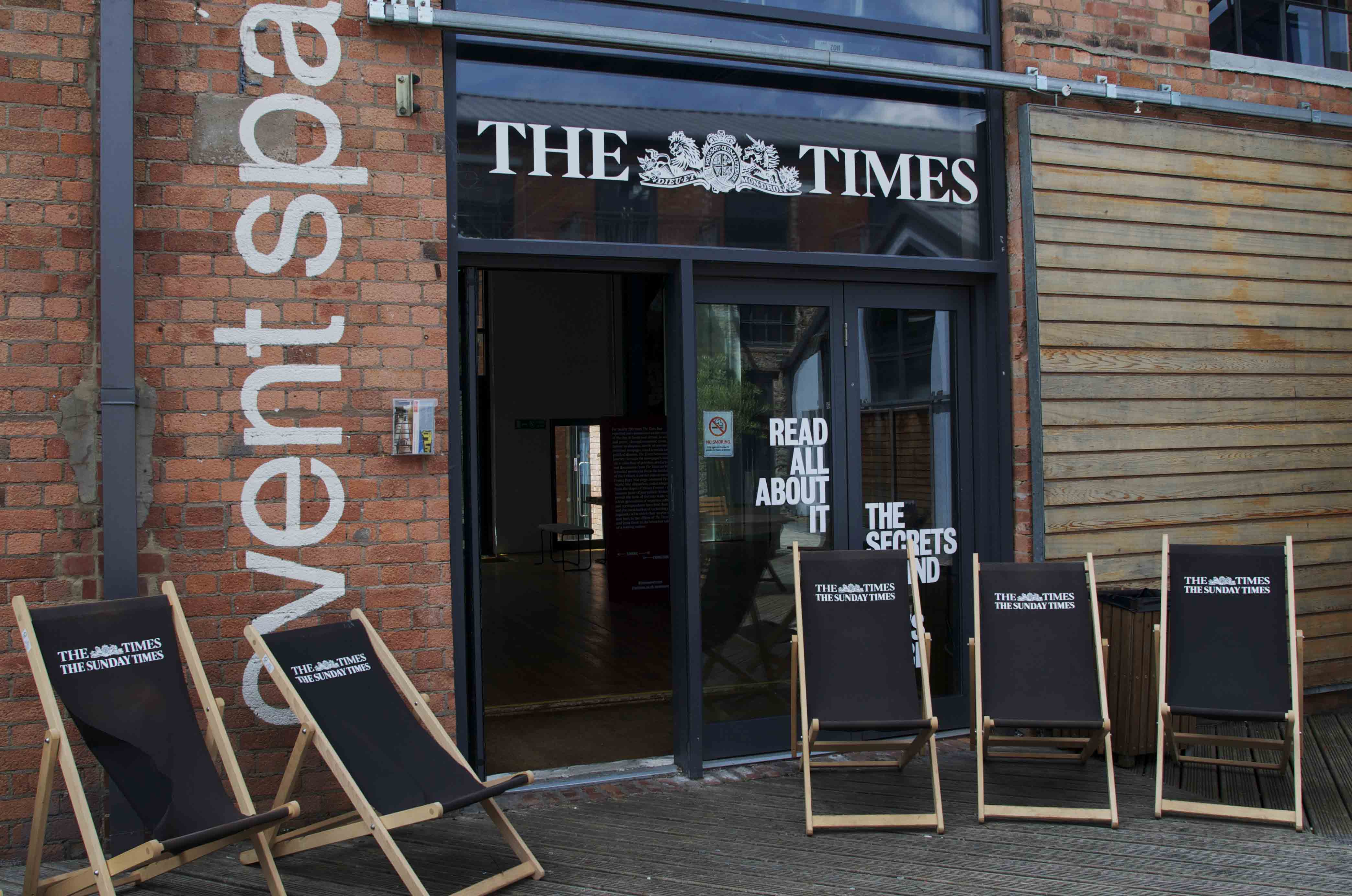 Modern event space entrance with glass doors, perfect for networking and casual meetings.