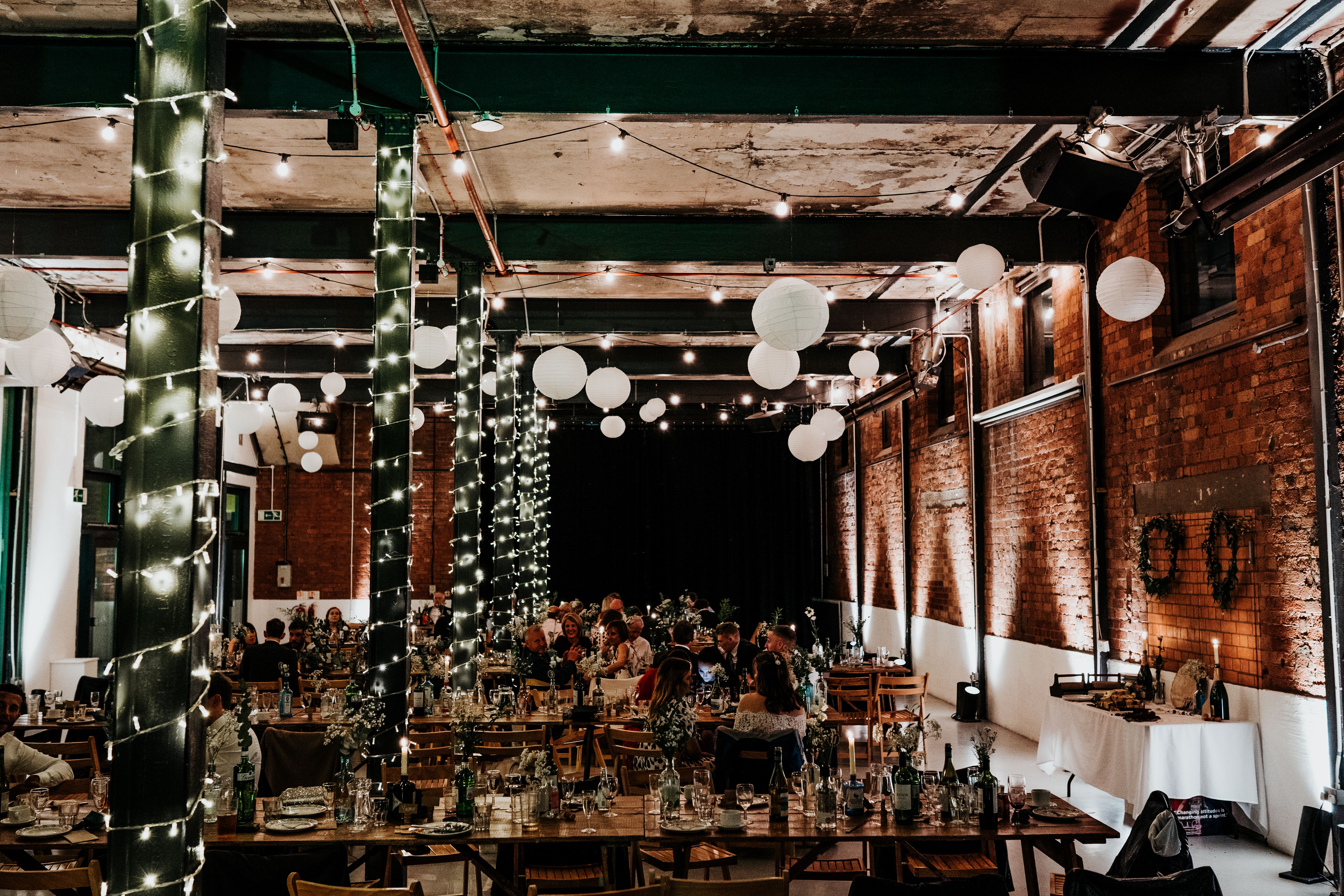 Rustic event space with brick walls, ideal for weddings and corporate gatherings.