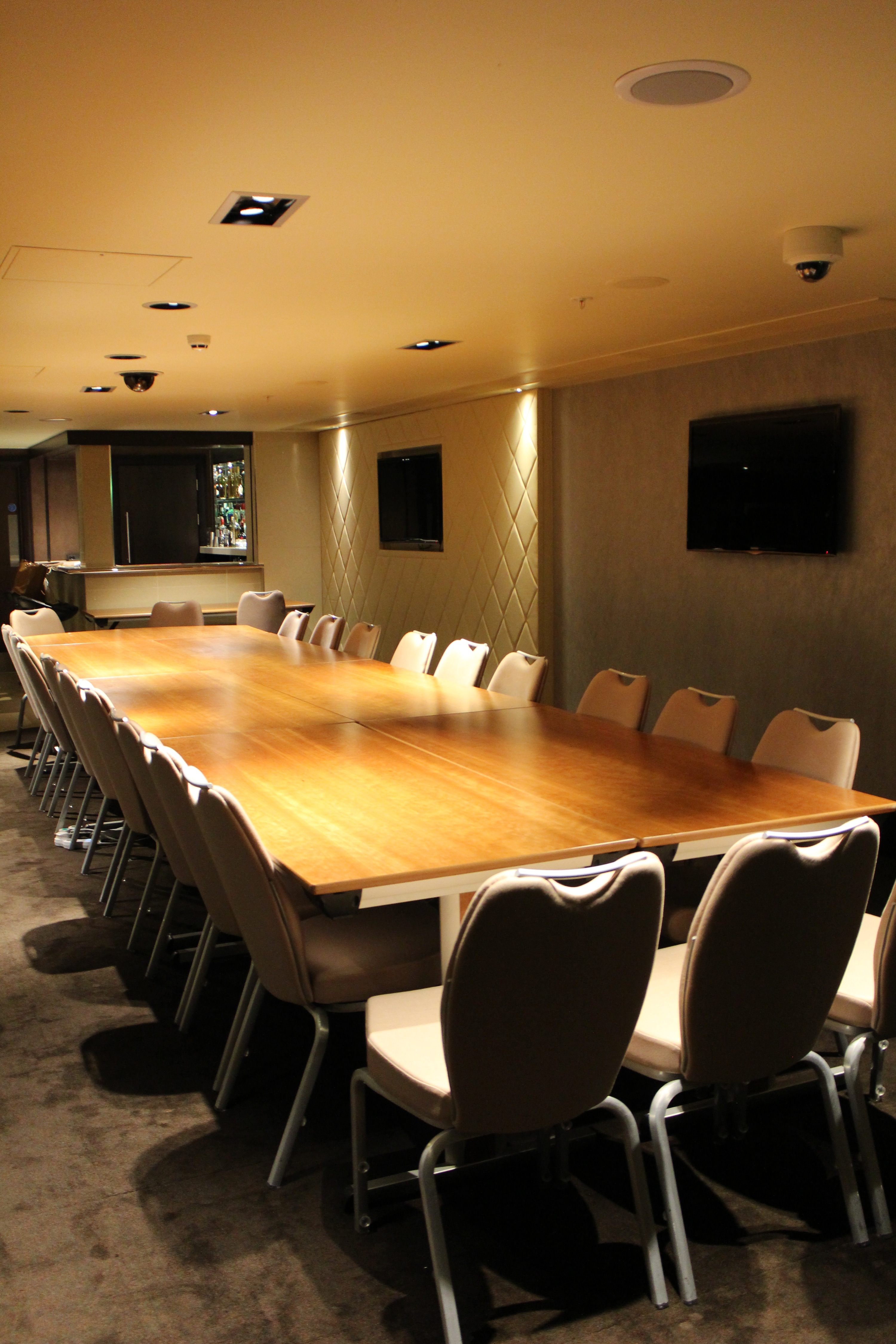 Conference room at Balcony Bar, Genting Club Manchester, with polished wooden table and screens.
