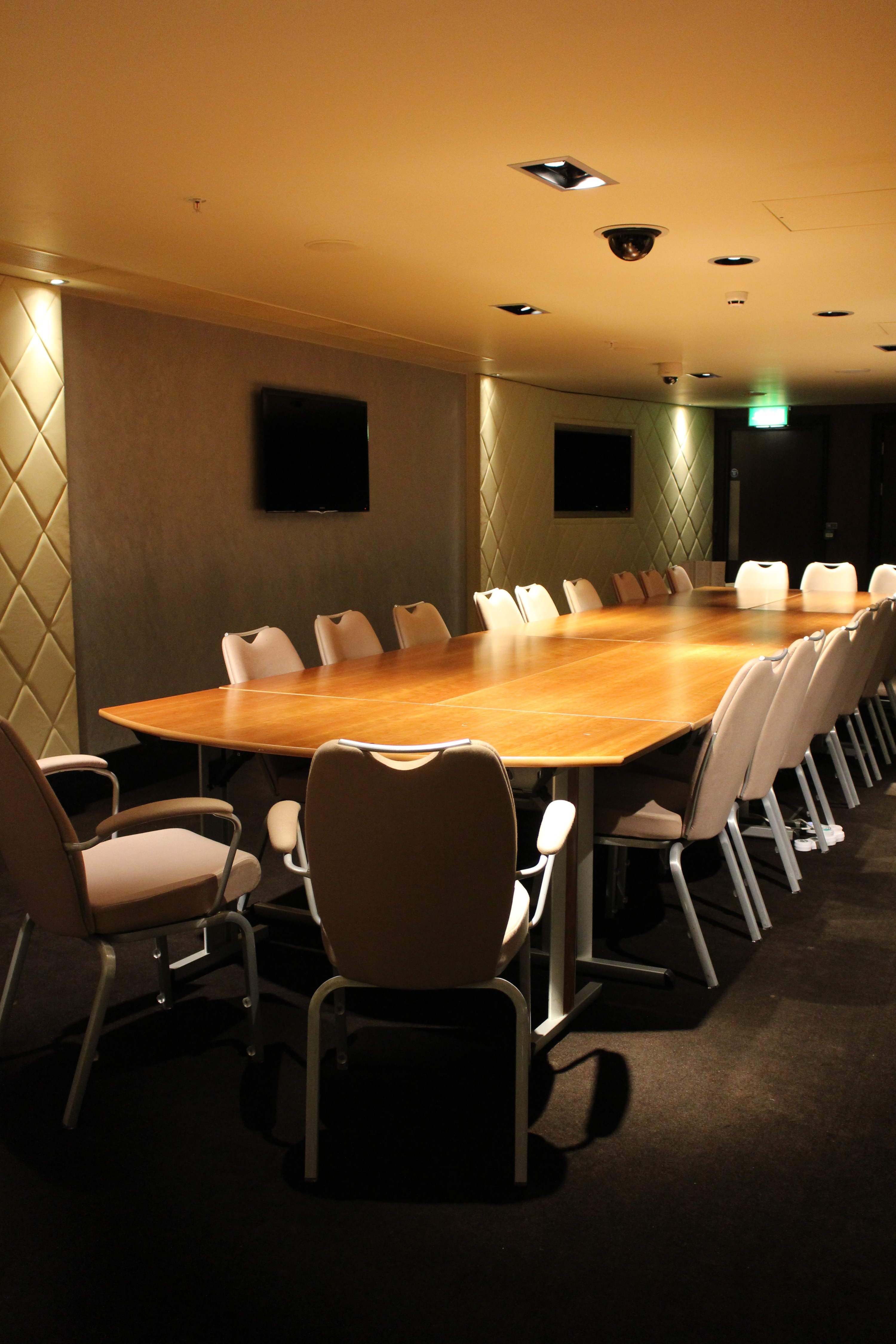 Balcony Bar conference room with polished wooden table, ideal for meetings and events.