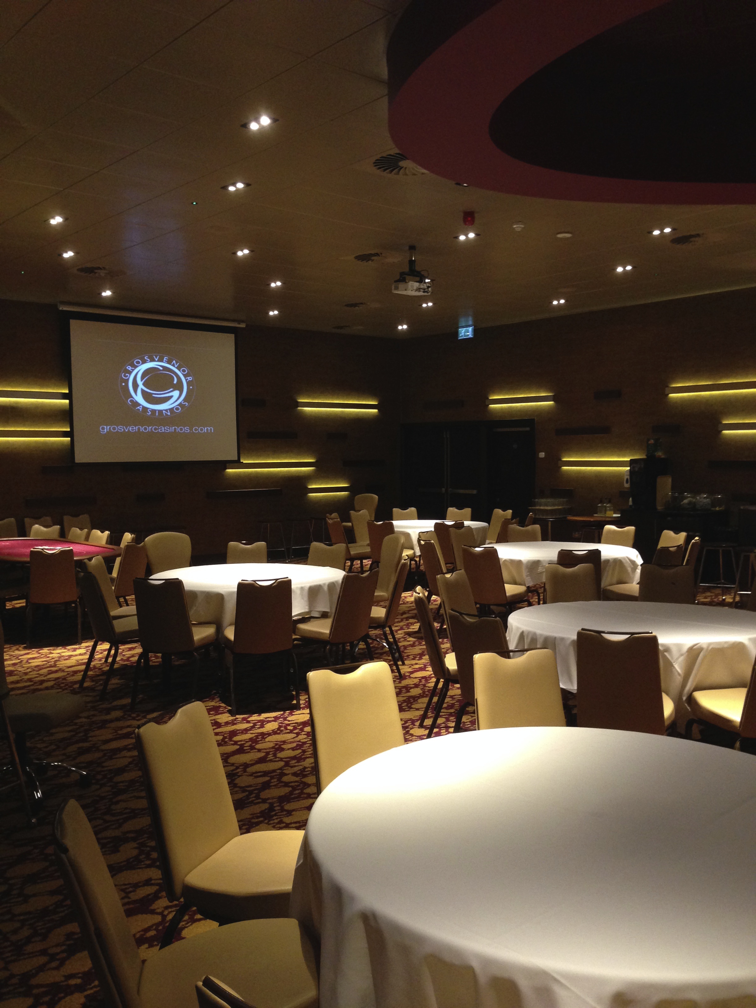 Grosvenor Casino Didsbury poker room with round tables, ideal for corporate events and meetings.