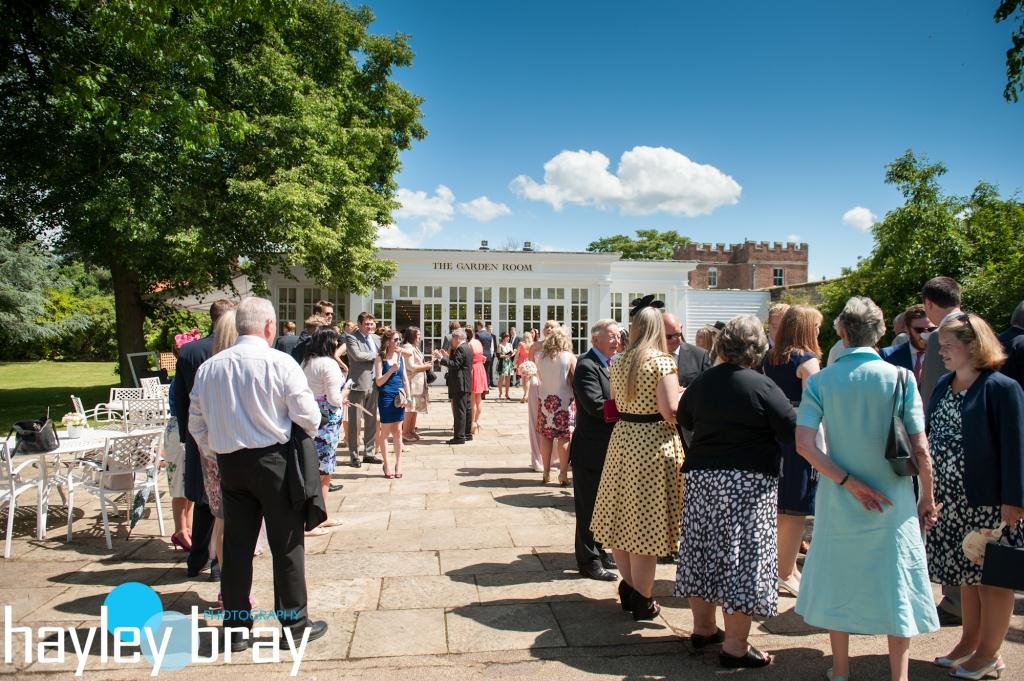 Outdoor networking event in The Garden Room, Hampton Court Palace, with lush greenery.