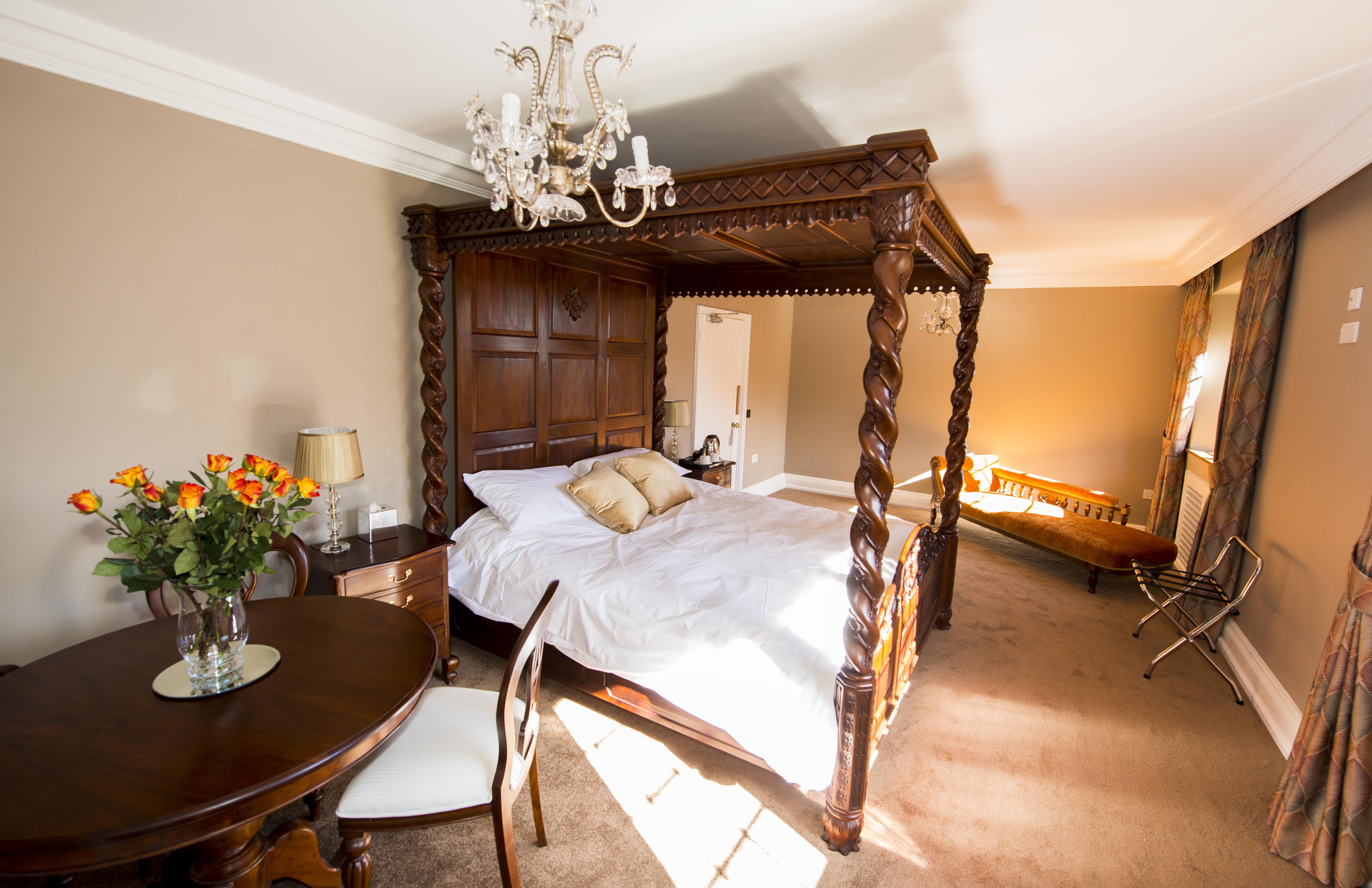 Luxurious four-poster bed in Port Lympne Hotel for intimate retreats and events.