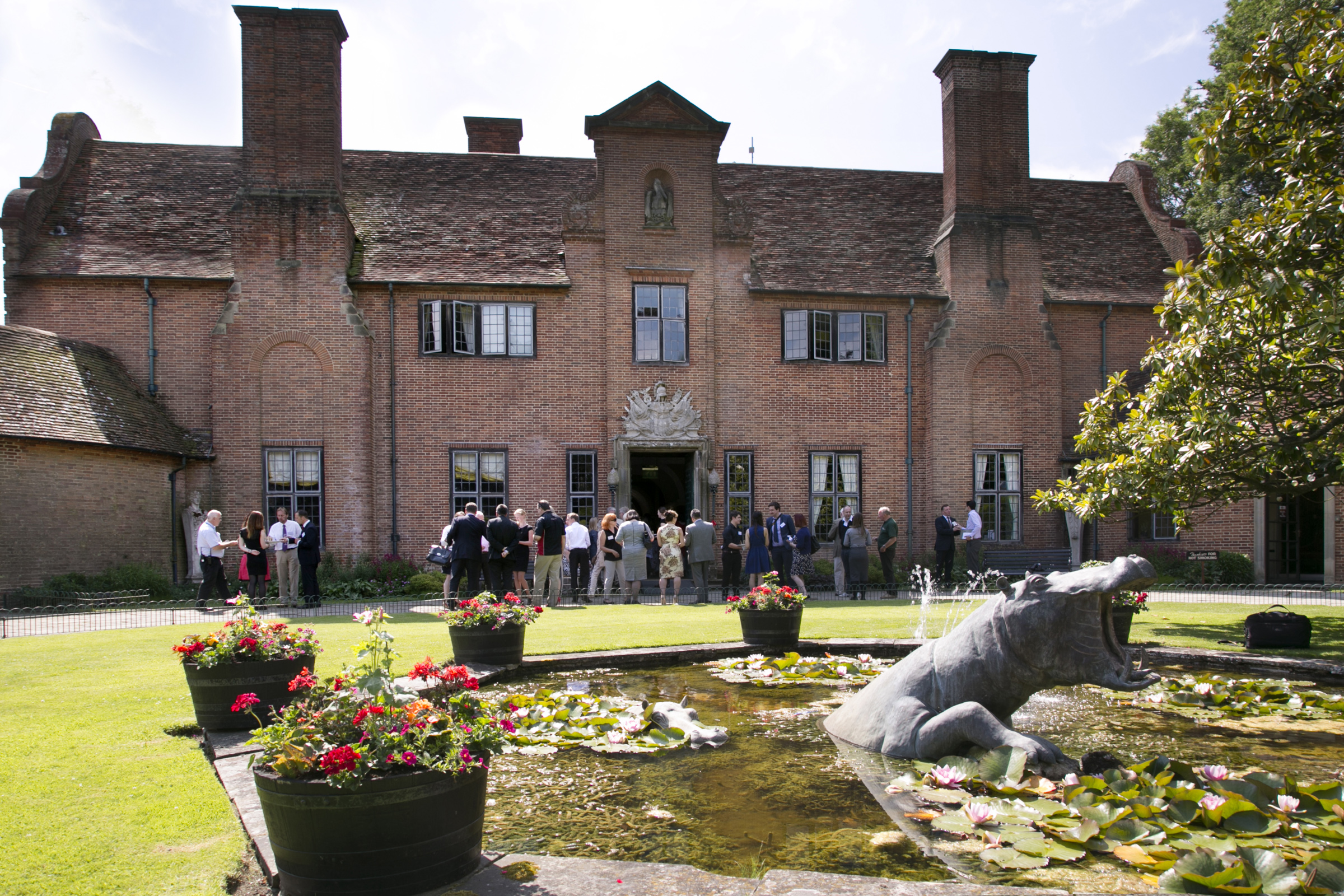 Charming outdoor venue at Port Lympne Hotel with historic brick facade for events.