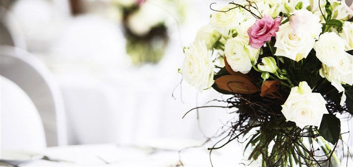 Elegant floral arrangement with white roses in Barbirolli Room, ideal for weddings and events.
