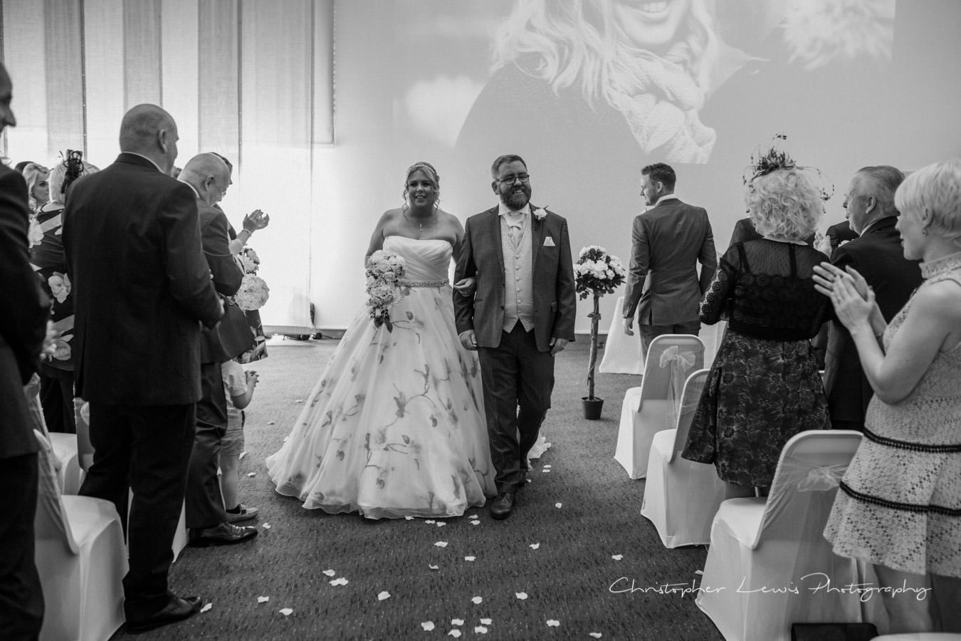 Joyful couple walking down the aisle in Barbirolli Room, perfect for weddings and events.