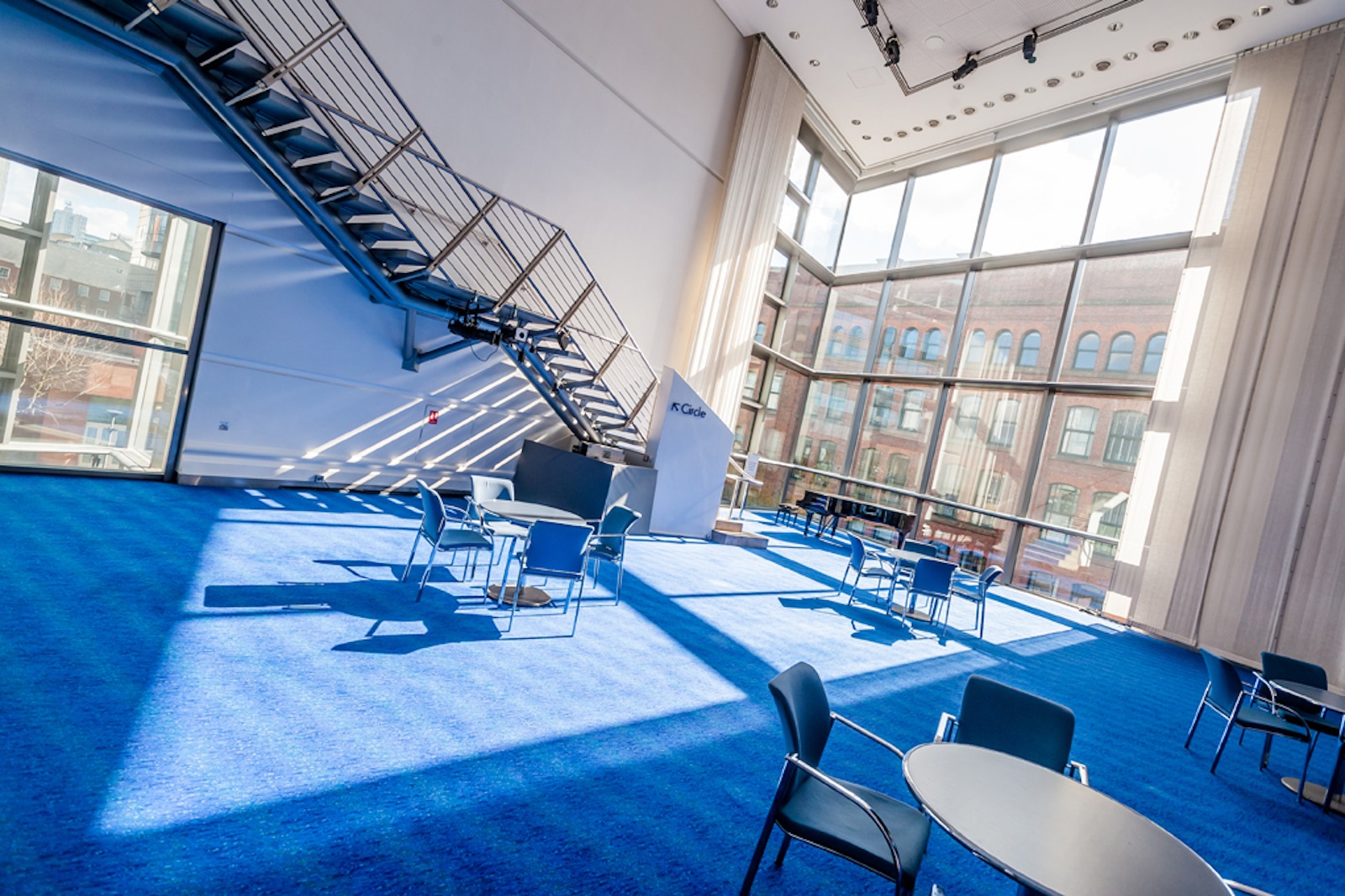 Barbirolli Room at Bridgewater Hall with modern staircase and vibrant blue carpet for events.