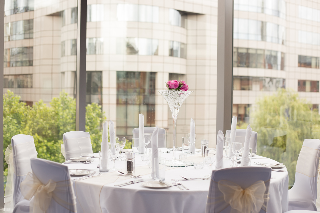 Elegant round table setup with floral arrangements in Bridgewater Hall for weddings or corporate events.