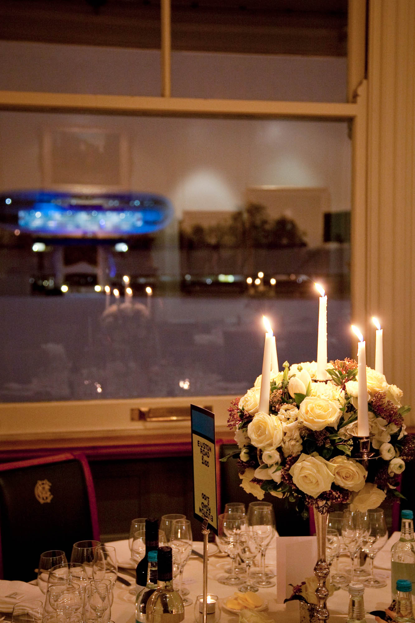 Elegant table with white roses in Long Room, Lord's Cricket Ground for upscale events.