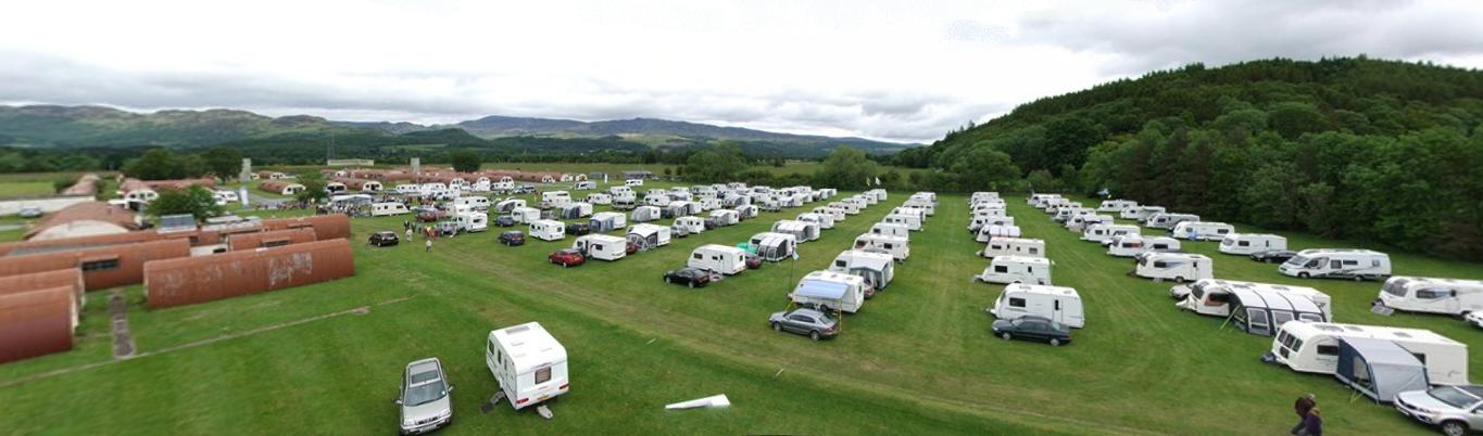 Outdoor venue at Cultybraggan POW Camp with caravans for team-building events.
