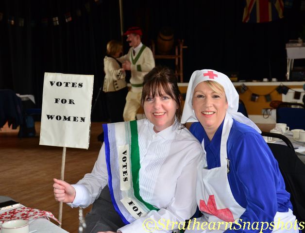 Women in period costumes at Cultybraggan POW Camp, celebrating women's suffrage event.