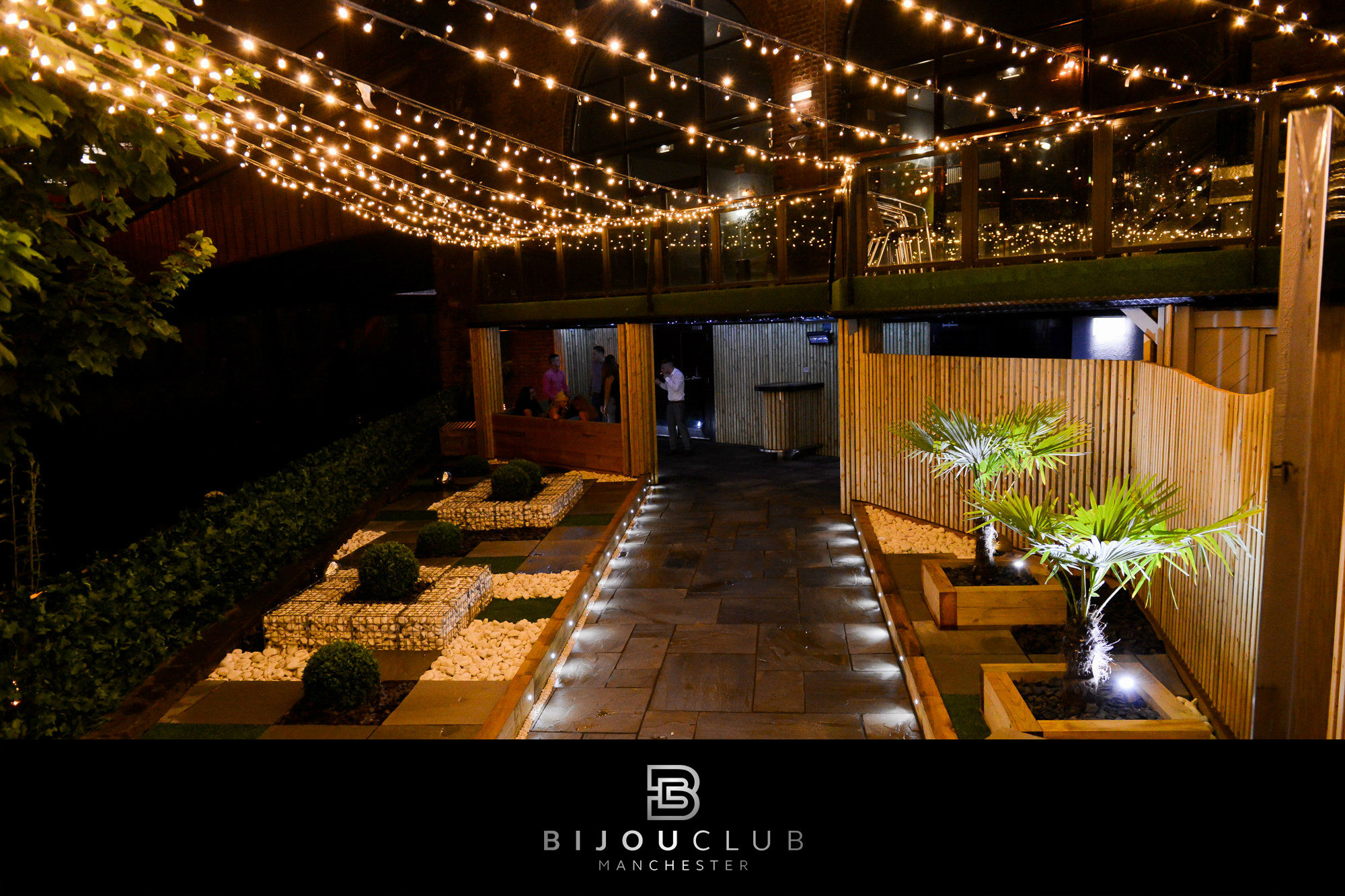 Outdoor cocktail bar at Bijou Club with string lights, ideal for upscale events.