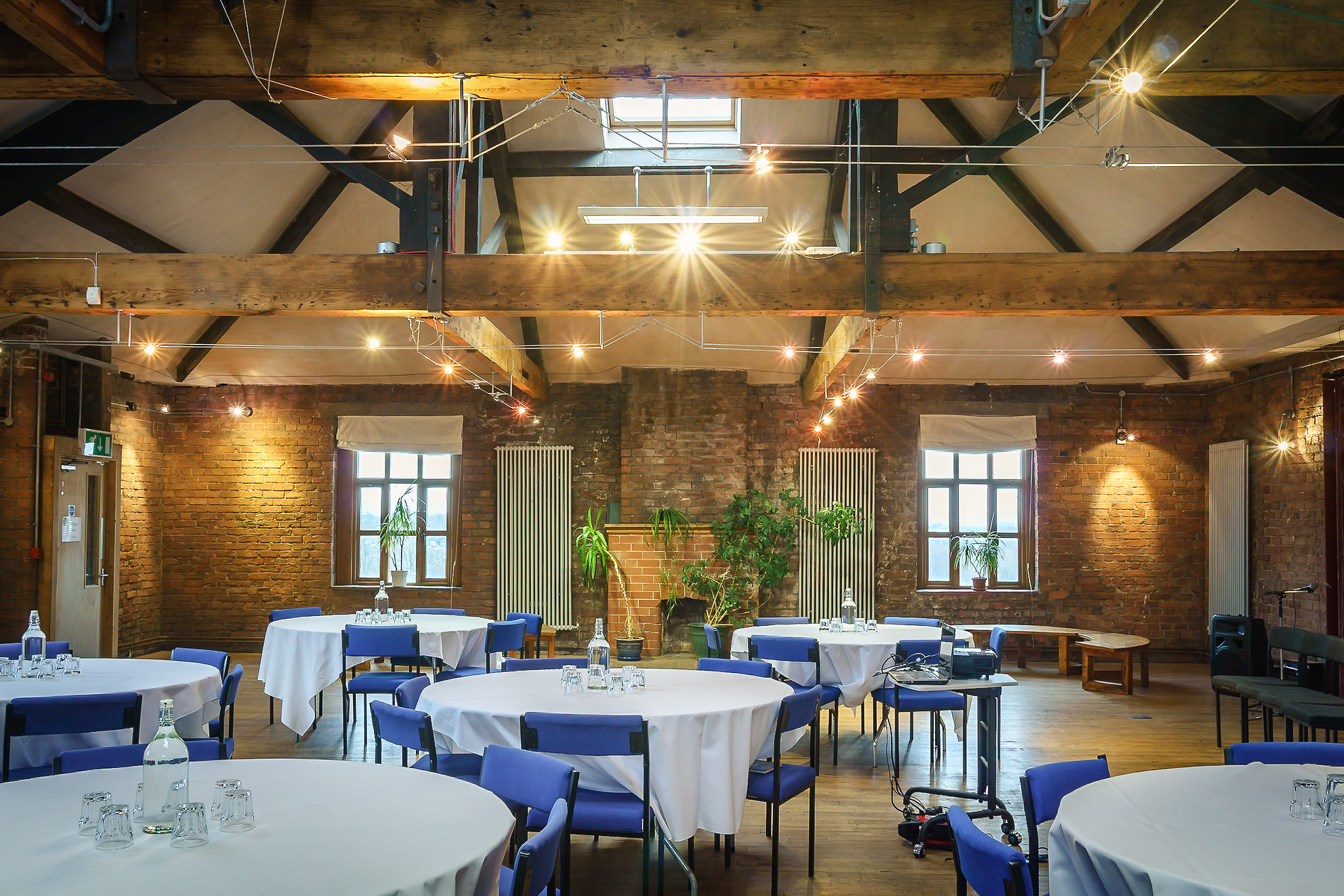 Silk Loft event space with rustic brick walls, perfect for corporate meetings and banquets.