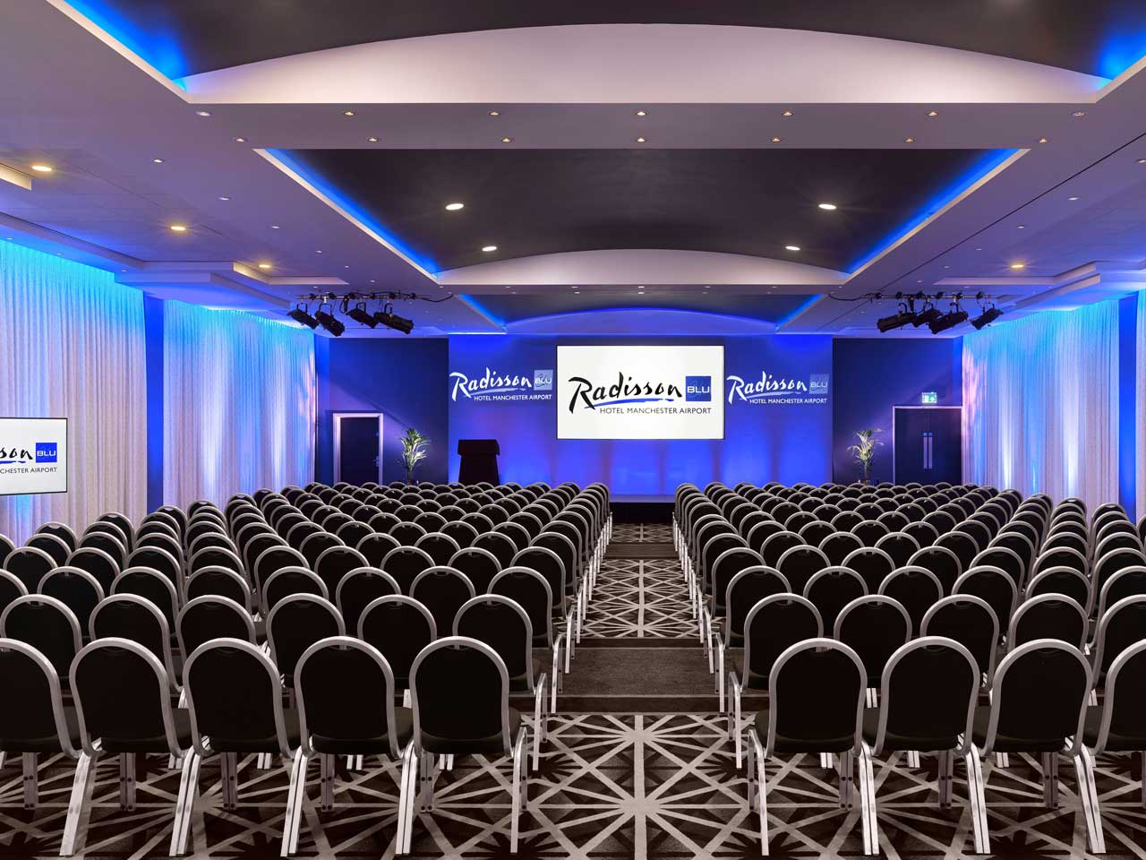 Manchester Suite at Radisson Blu: tiered seating for corporate events and presentations.