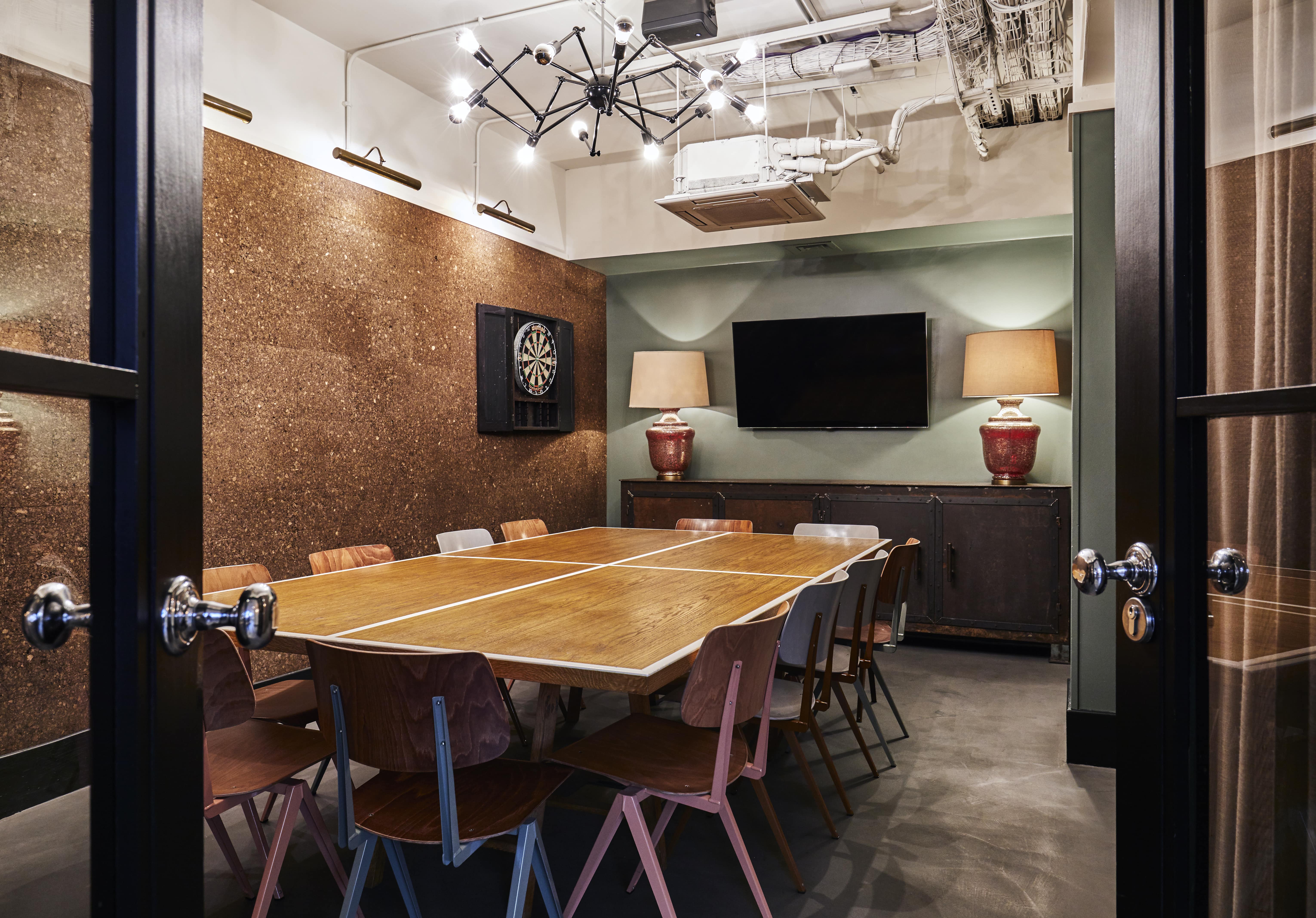 Modern meeting room in The Hoxton Shoreditch with wooden table, ideal for collaboration.