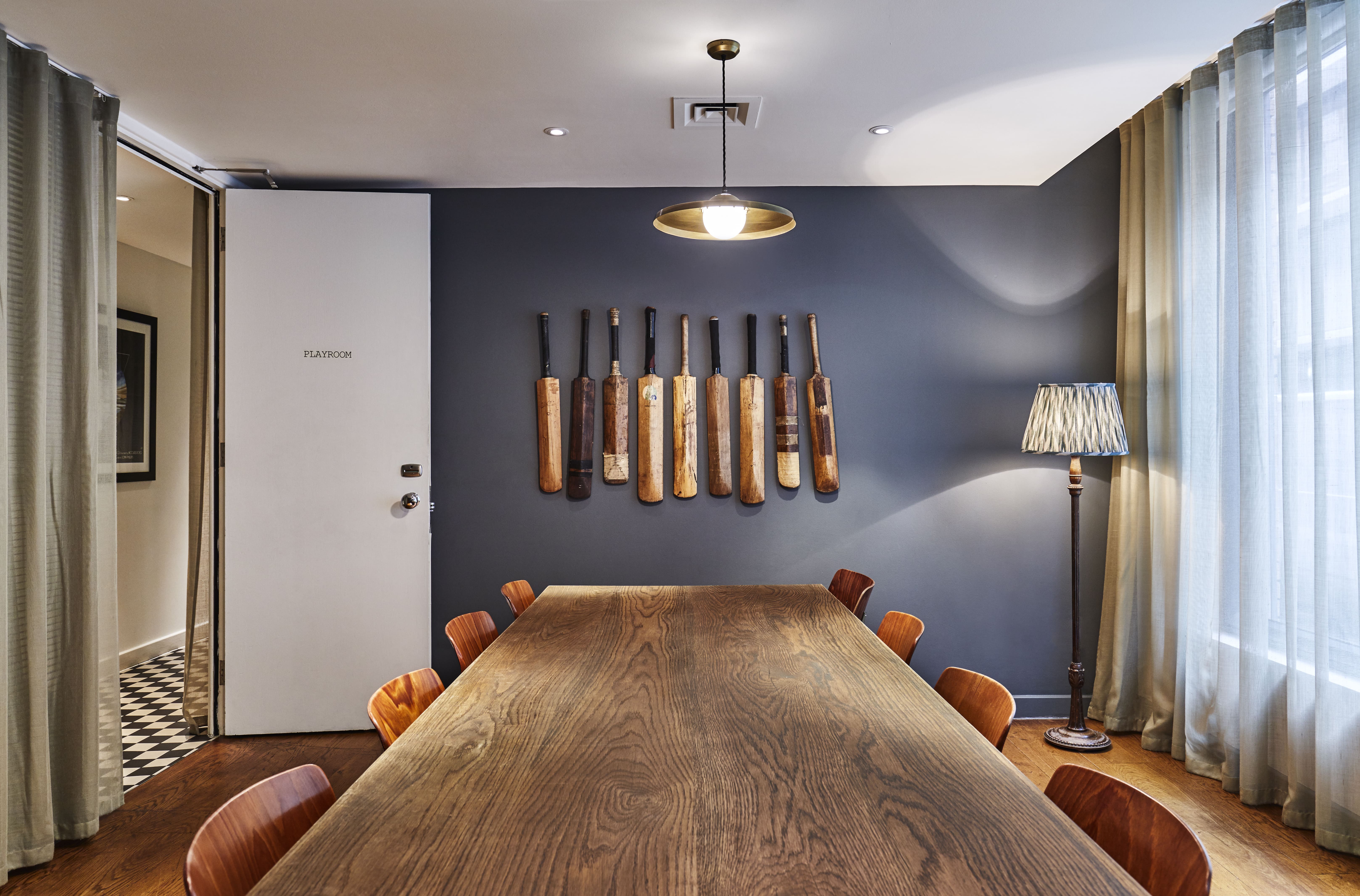 Stylish meeting room with wooden table and paddle decor at The Hoxton Shoreditch.