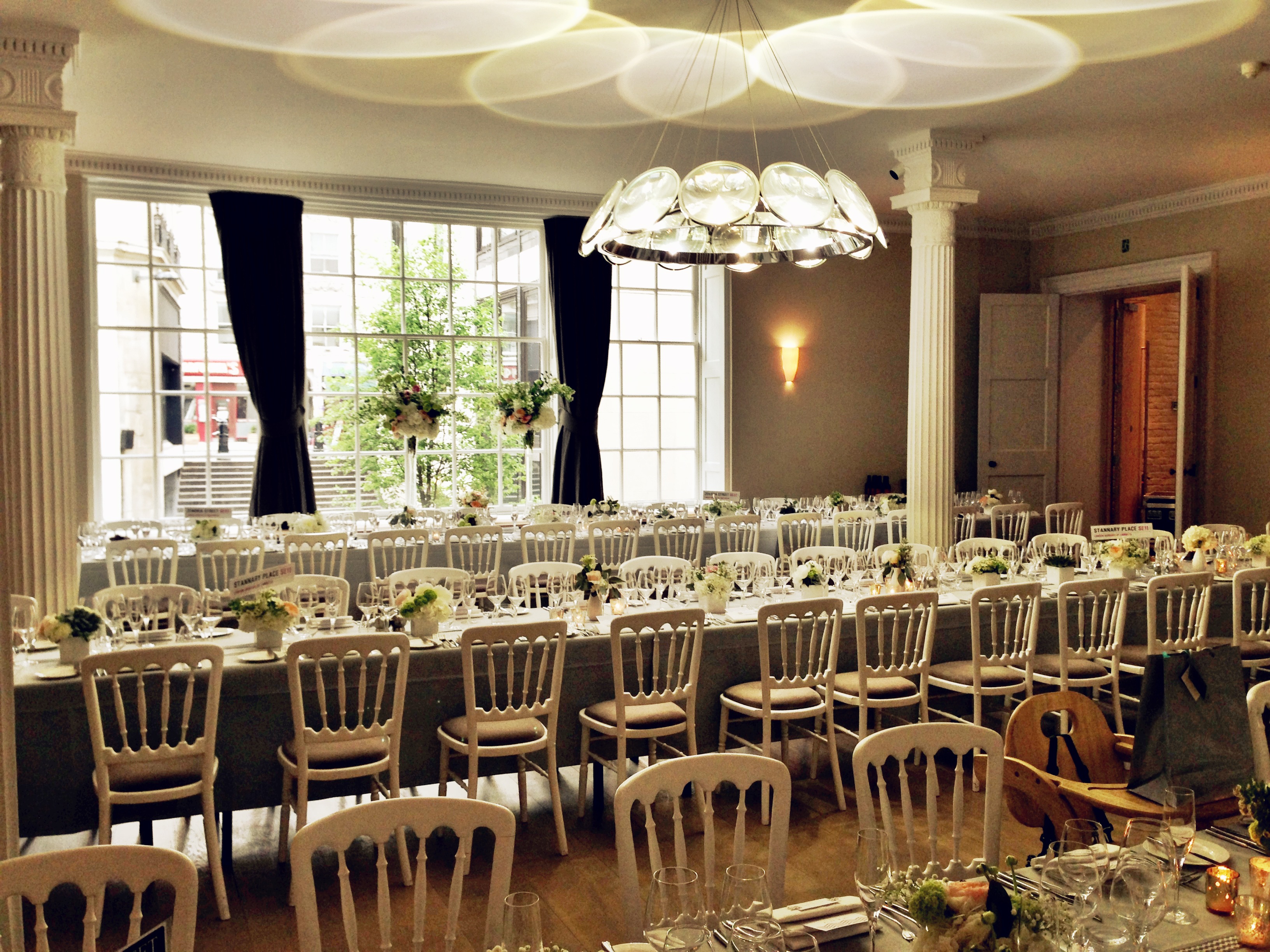 Elegant Benjamin Franklin Room with floral centerpieces, ideal for formal dinners and gatherings.