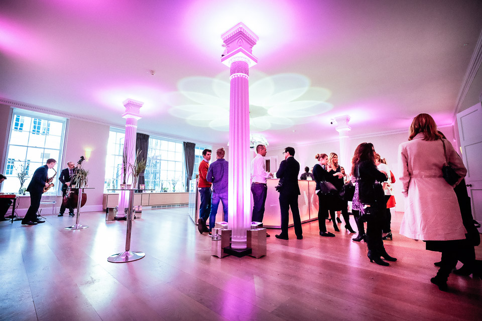 Elegant Benjamin Franklin Room with purple uplighting for corporate events and celebrations.