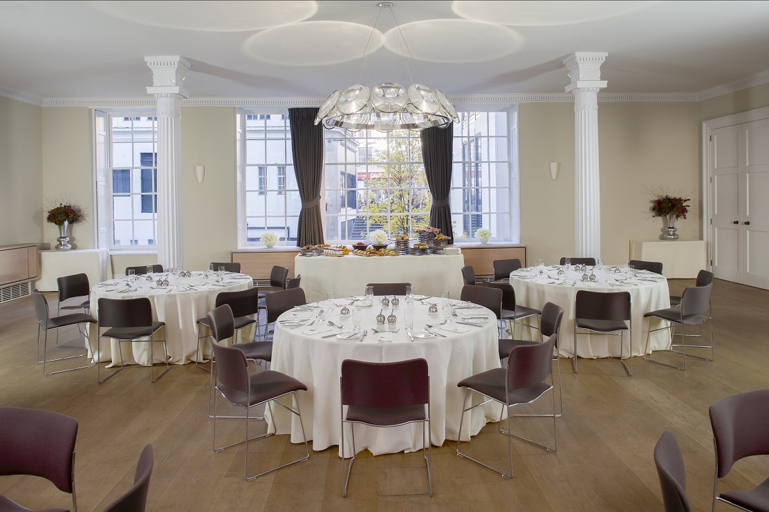 Elegant Benjamin Franklin Room set for formal corporate event with natural light.