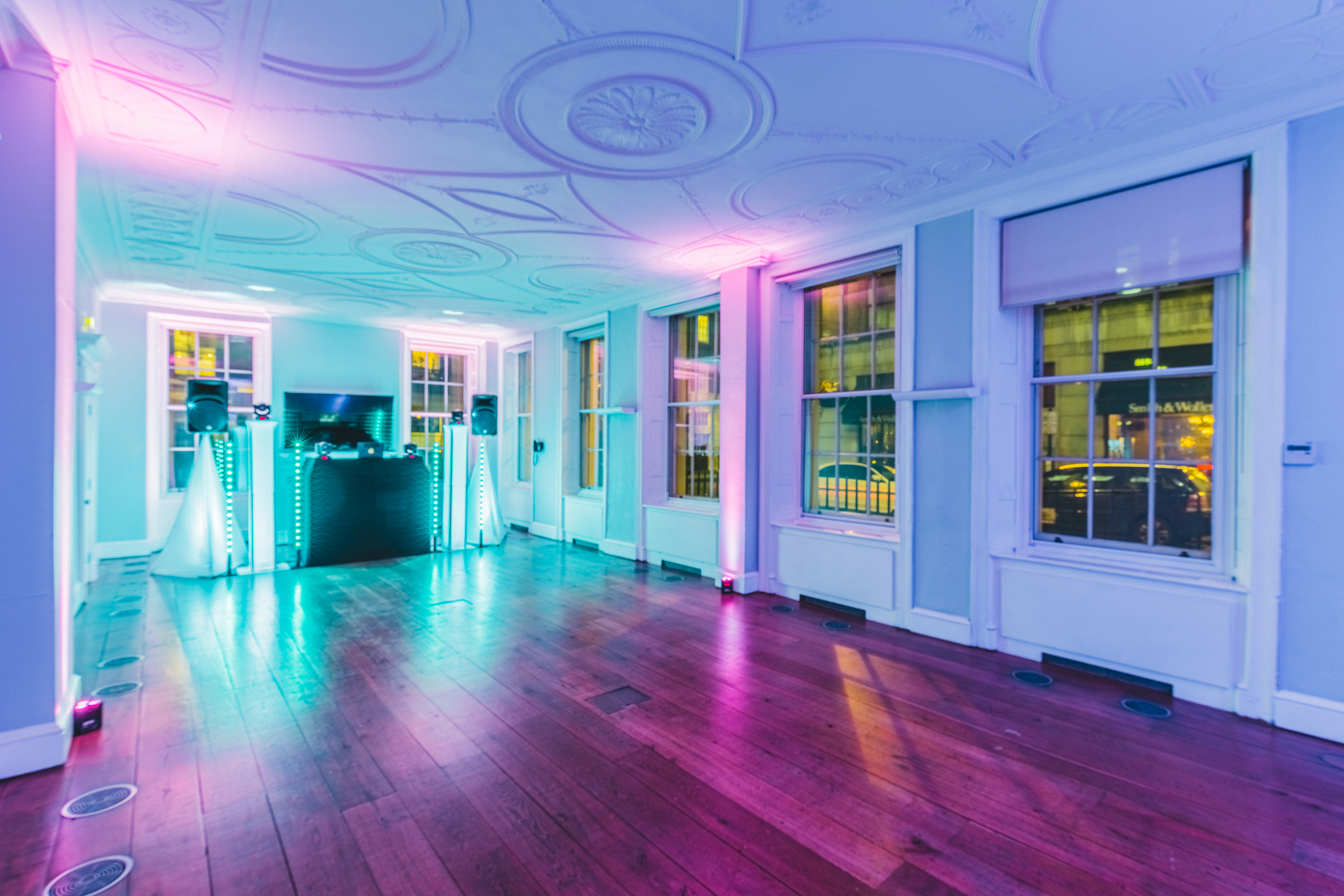 Modern event space with vibrant lighting and sleek bar at RSA House for gatherings.