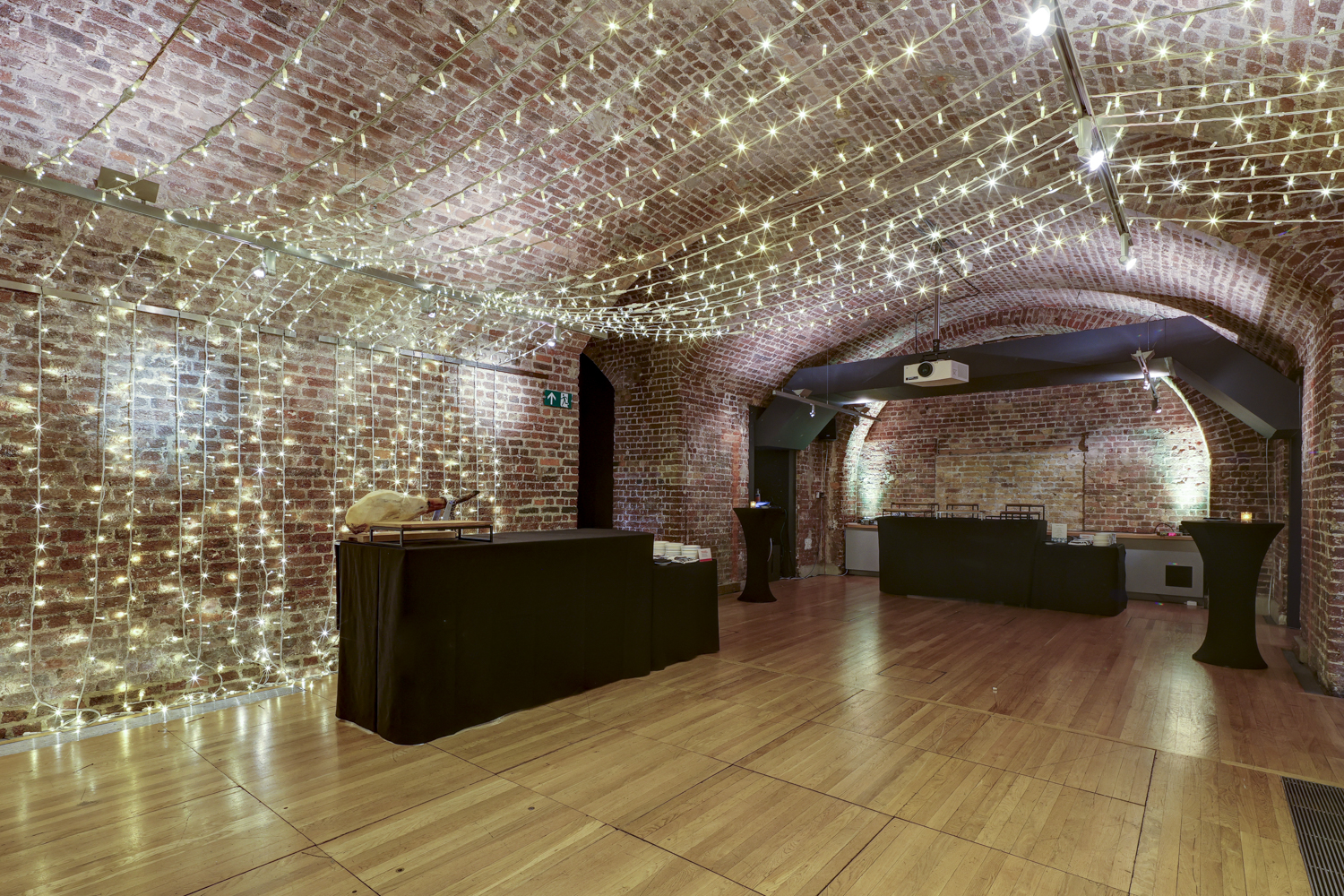 The Vaults at RSA House: elegant event space with exposed brick and fairy lights.