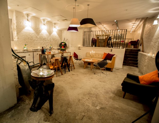 Stylish event space at The Anthologist with warm lighting and exposed brick walls.