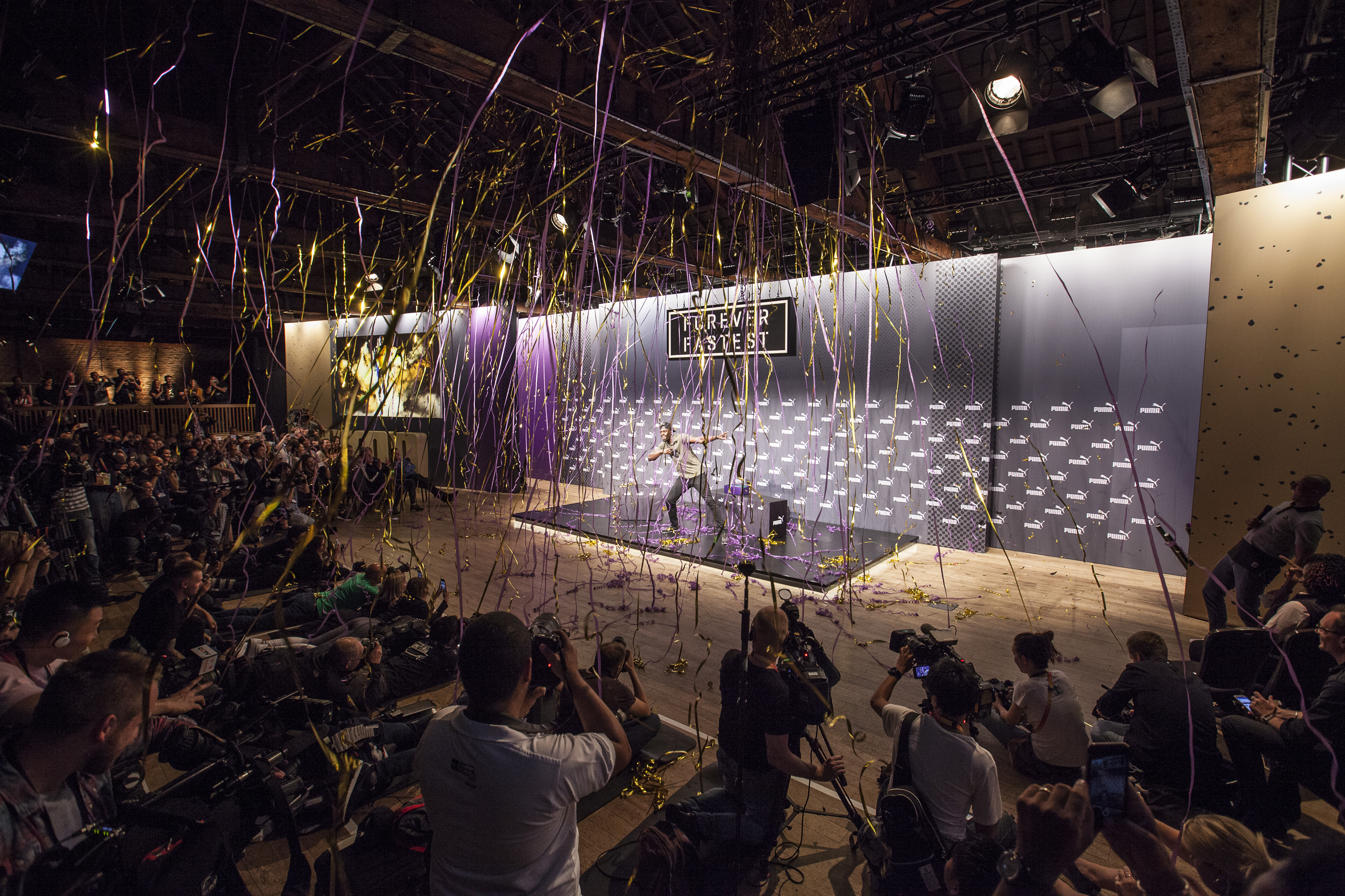Dynamic event at The Porter Tun with stage backdrop and confetti celebration.