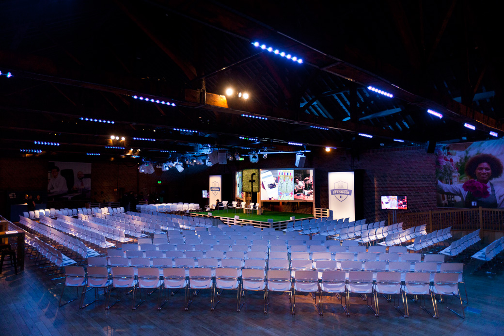 Event space at The Porter Tun with spacious seating and large screens for presentations.