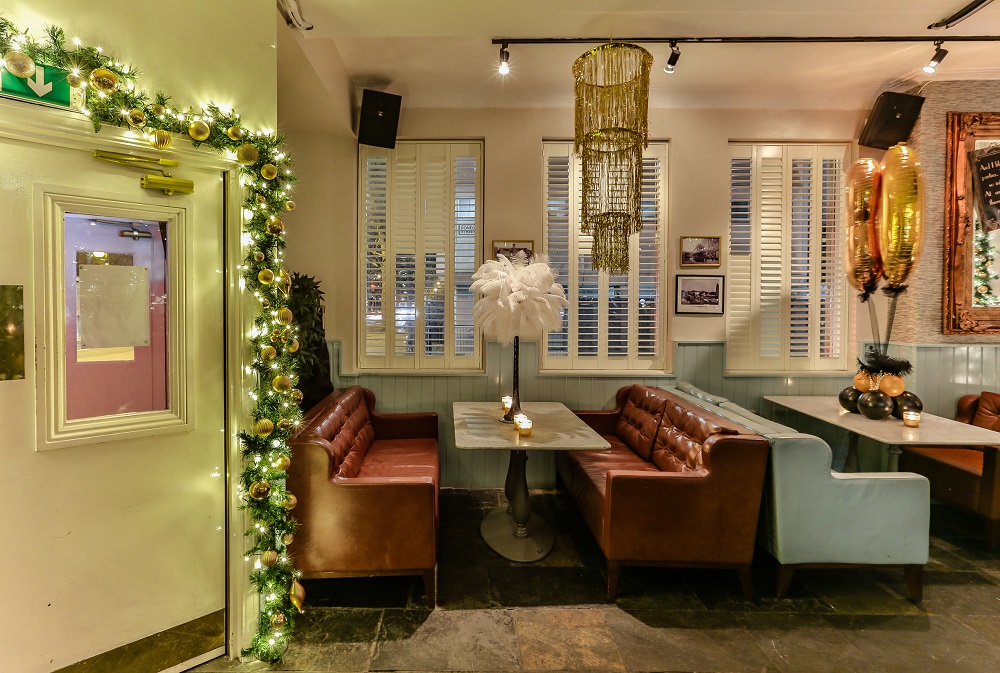 Stylish event space with leather seating, perfect for holiday parties and gatherings.