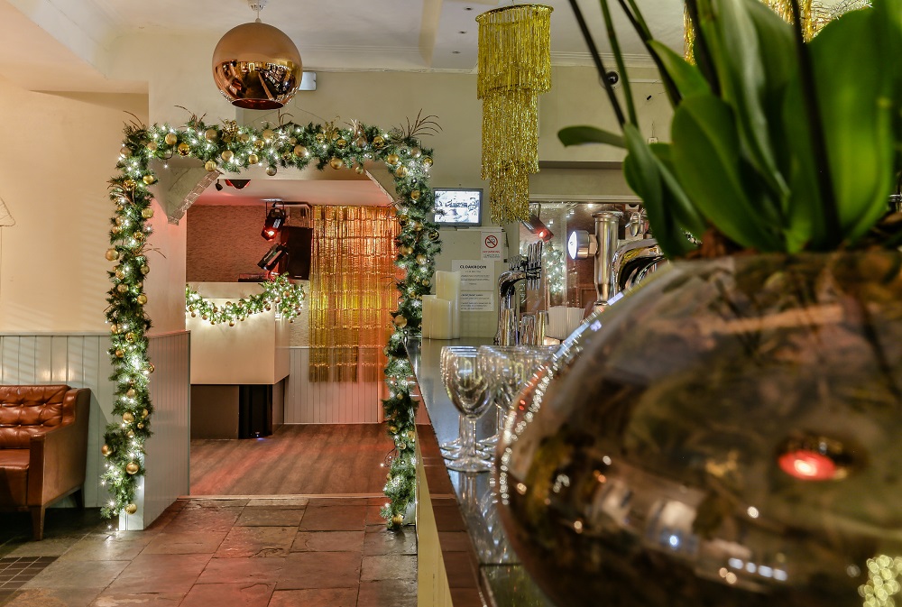 The Saloon entrance at The Chapel Bar, adorned with festive lights for events.