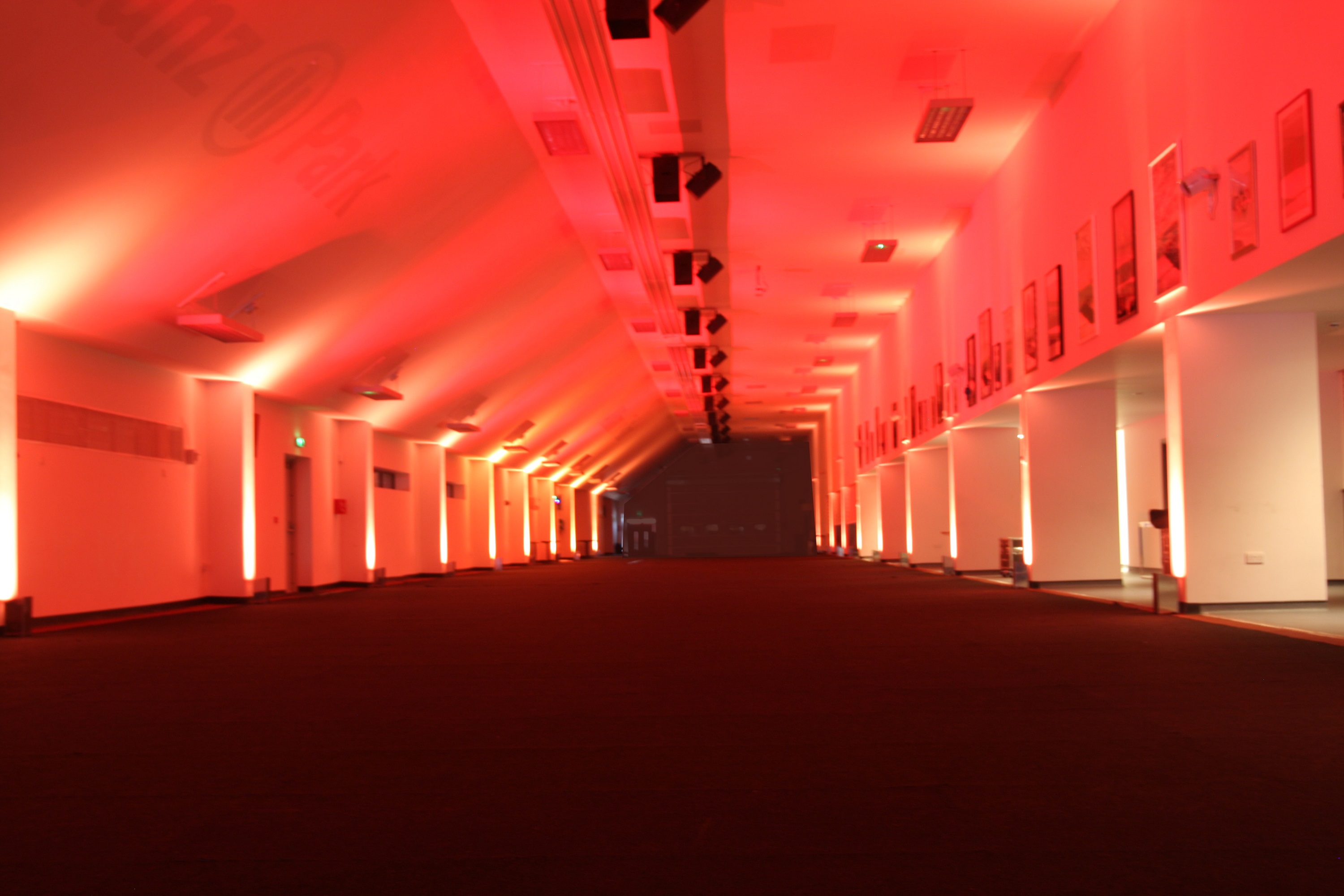 Spacious Olympic Bar at StoneX Stadium with red lighting for events and exhibitions.