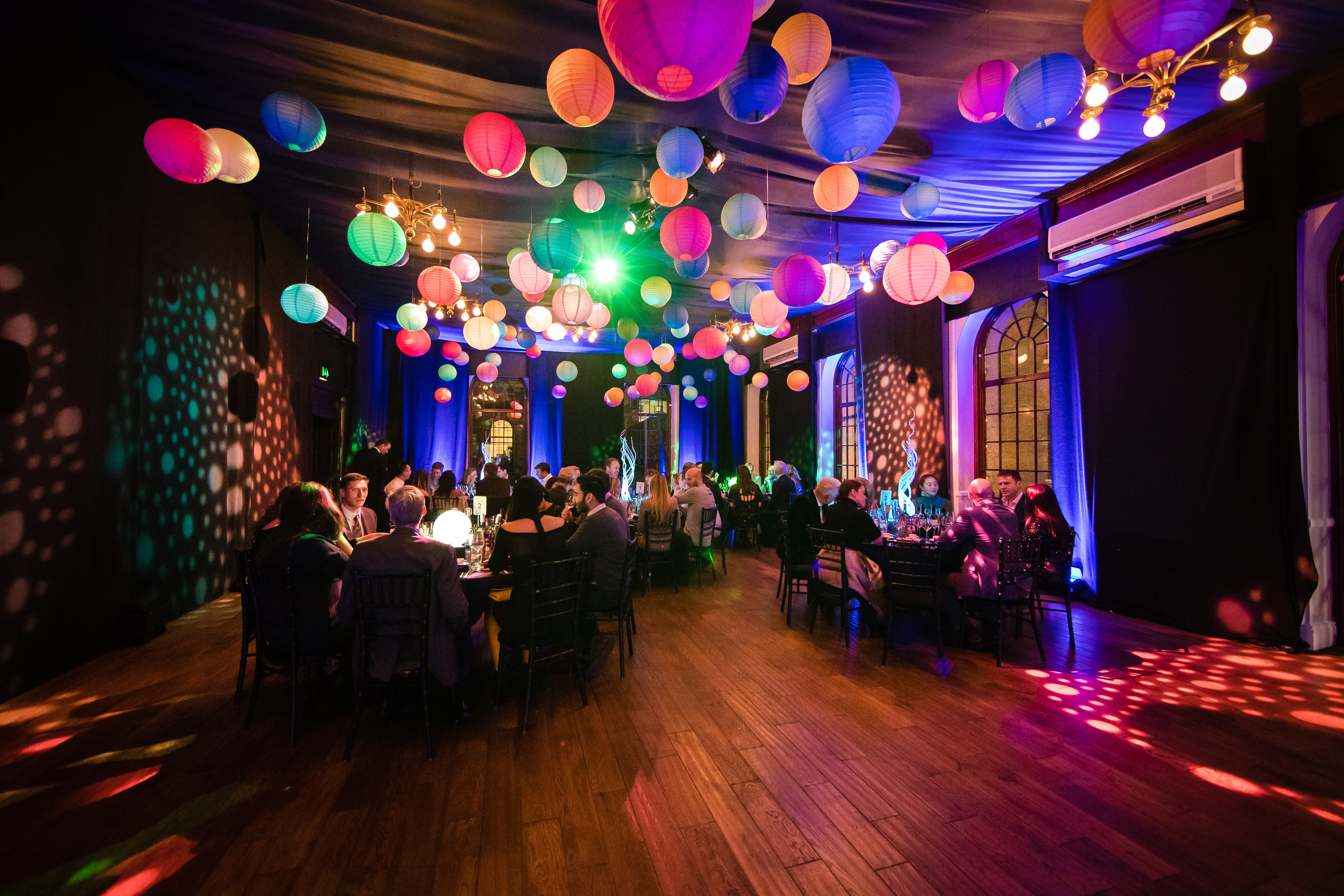 Vibrant event space with colorful lanterns, perfect for celebrations and corporate gatherings.