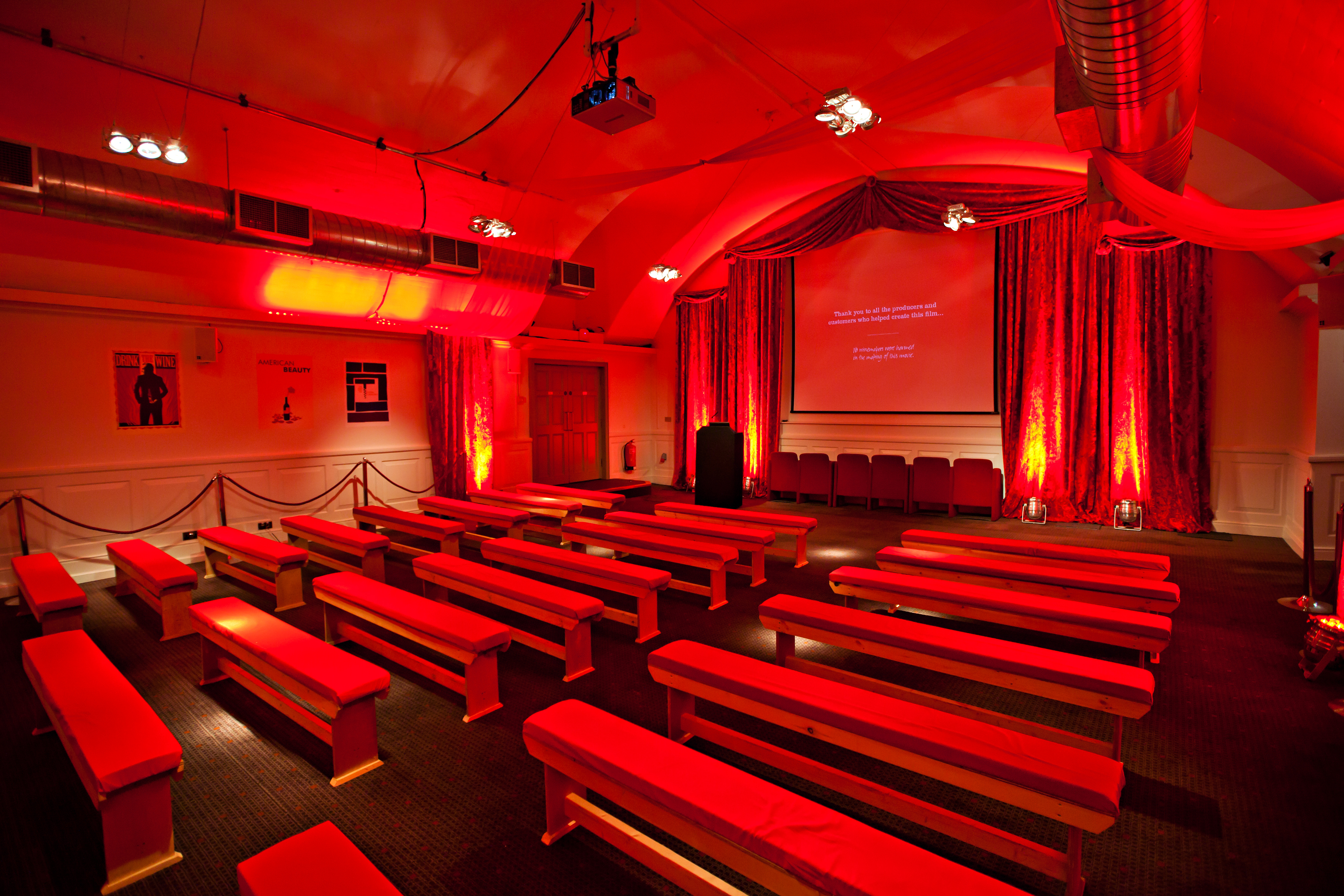 Smeaton Vaults event space with red drapery, ideal for presentations and workshops.