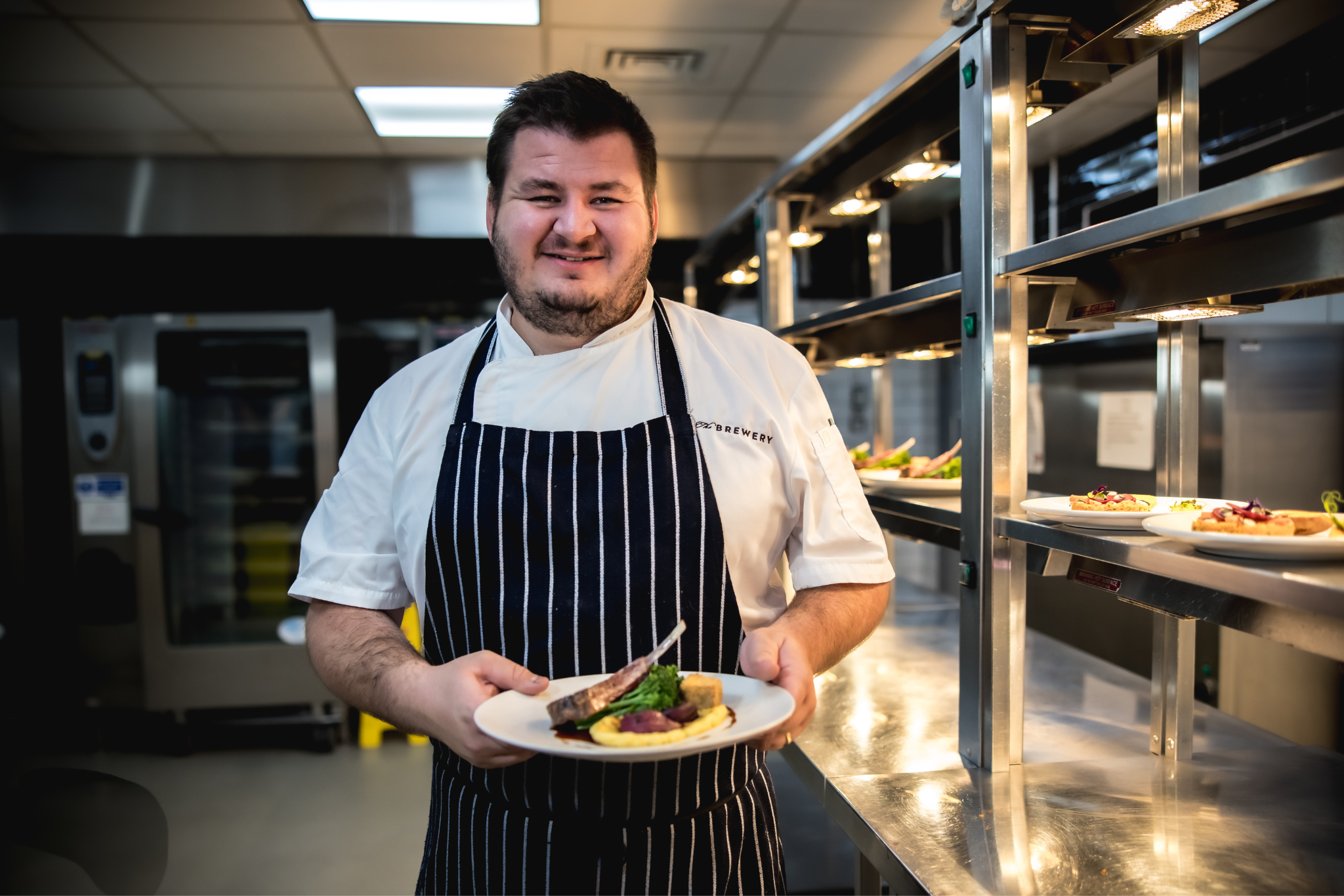 Chef presenting a beautifully plated dish at The Smeaton Vaults for events and catering.