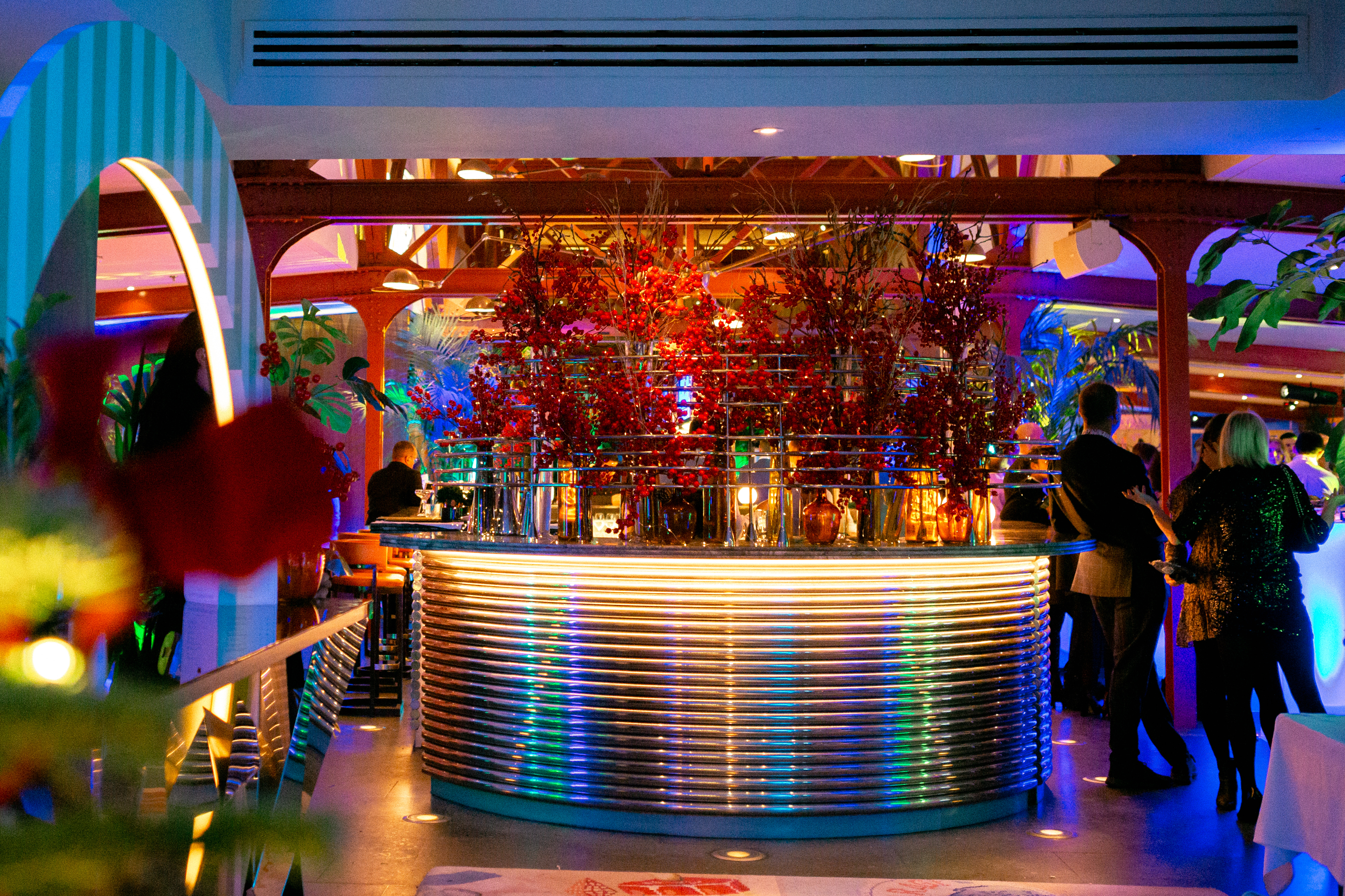 Vibrant Bluebird Chelsea restaurant bar with colorful lighting for upscale events.